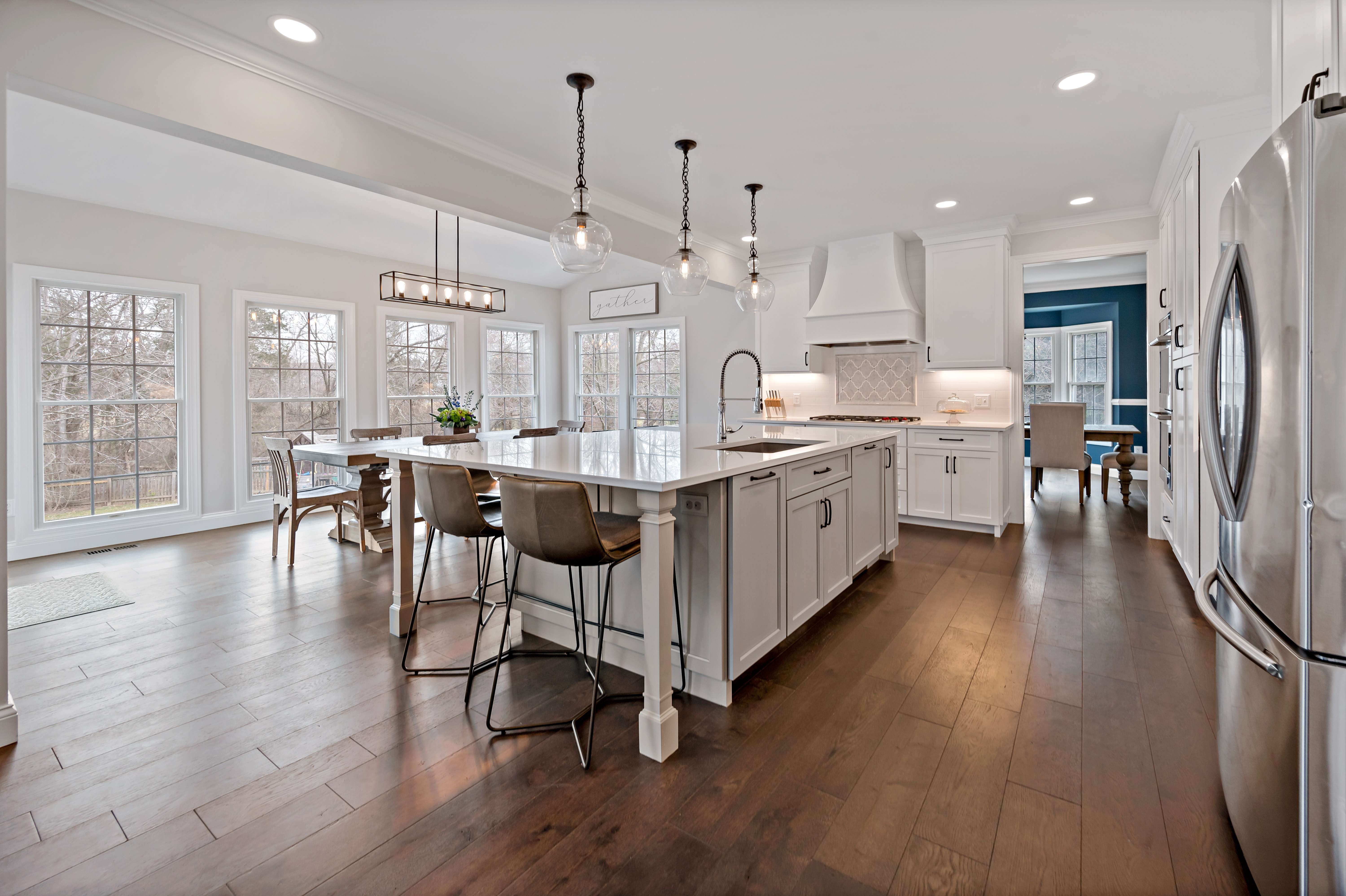 Open spacious white kitchen with hard wood floors