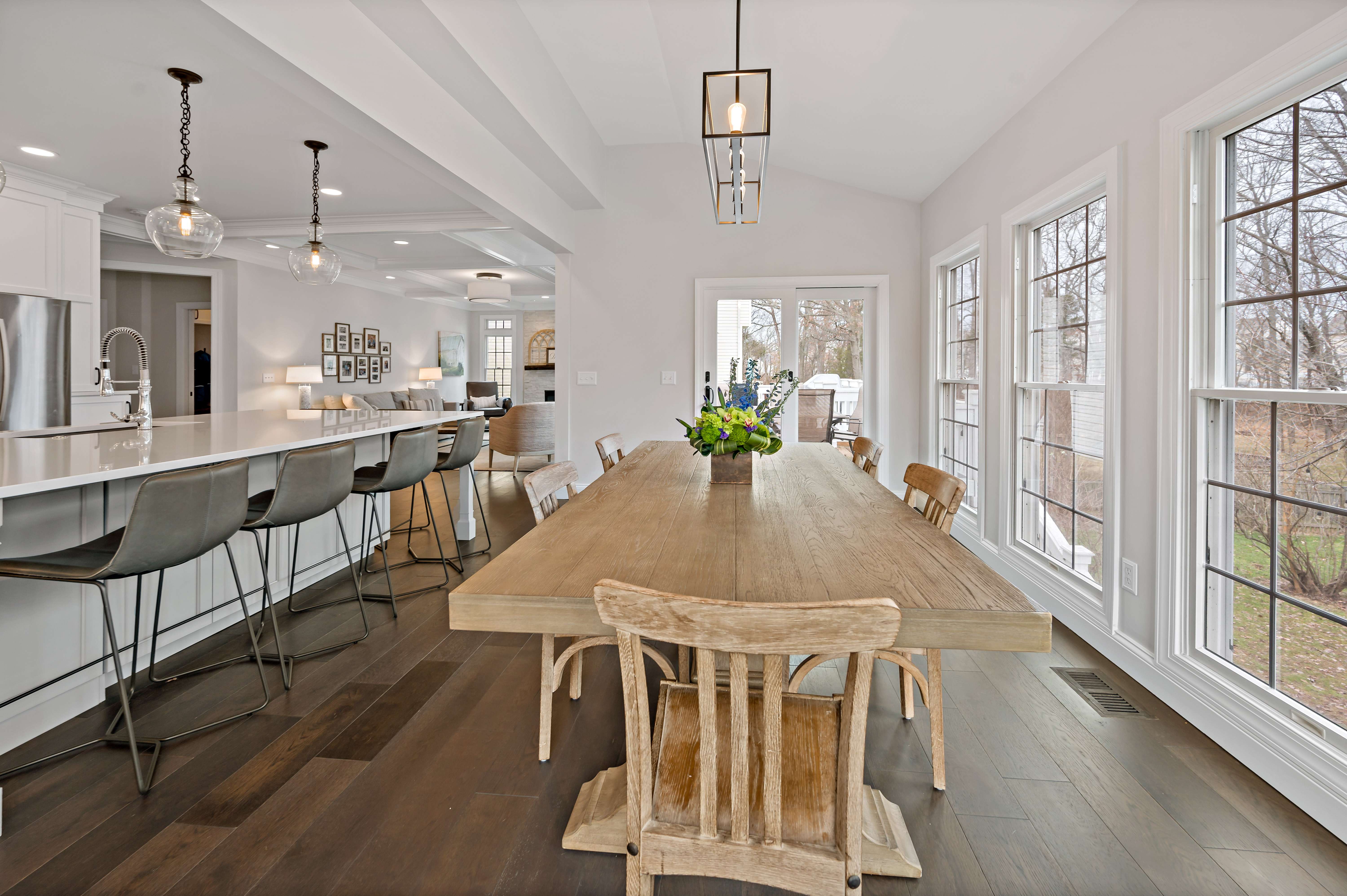 Light wood kitchen table with large windows