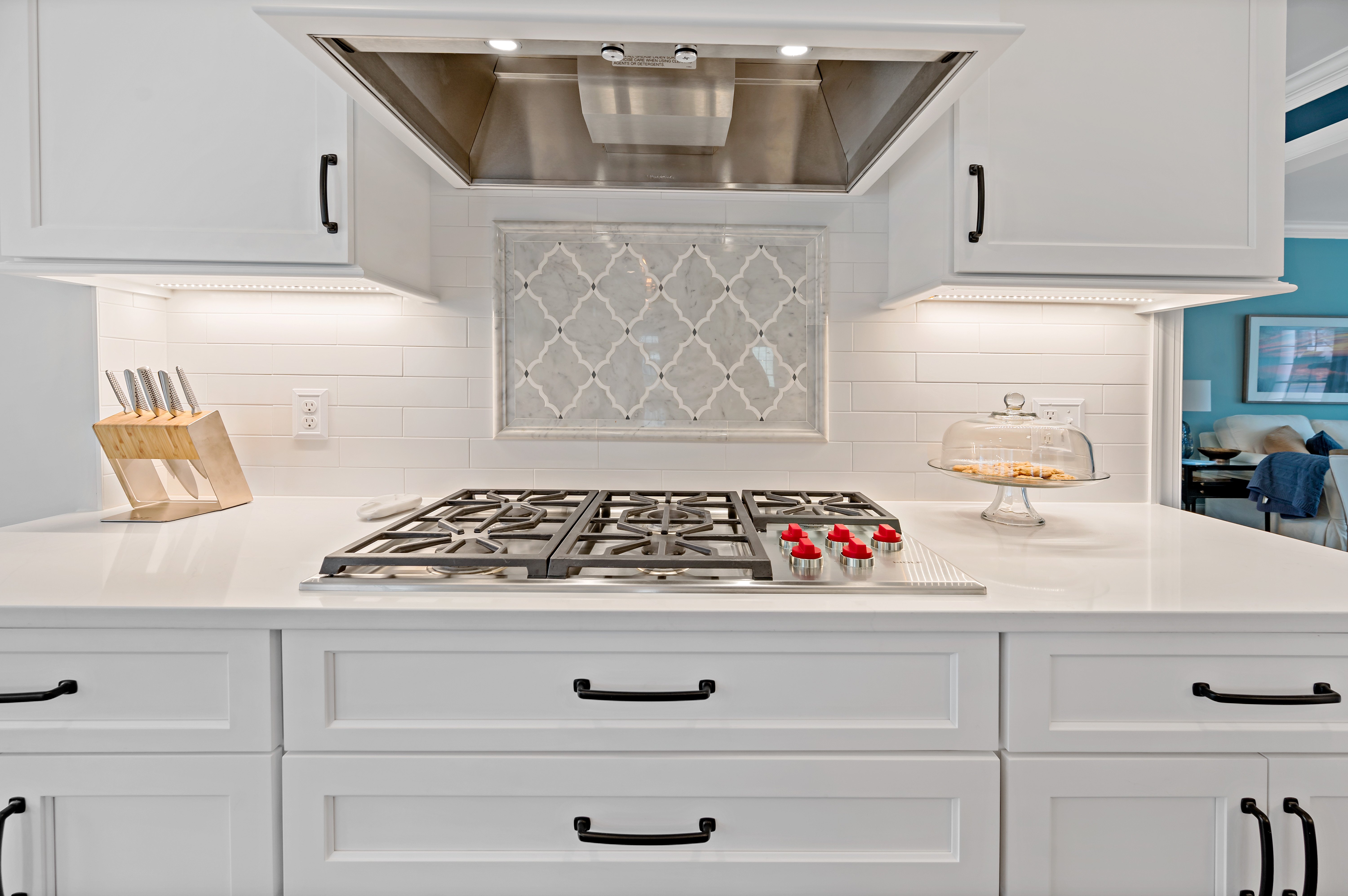 Gas stove top with white cabinetry