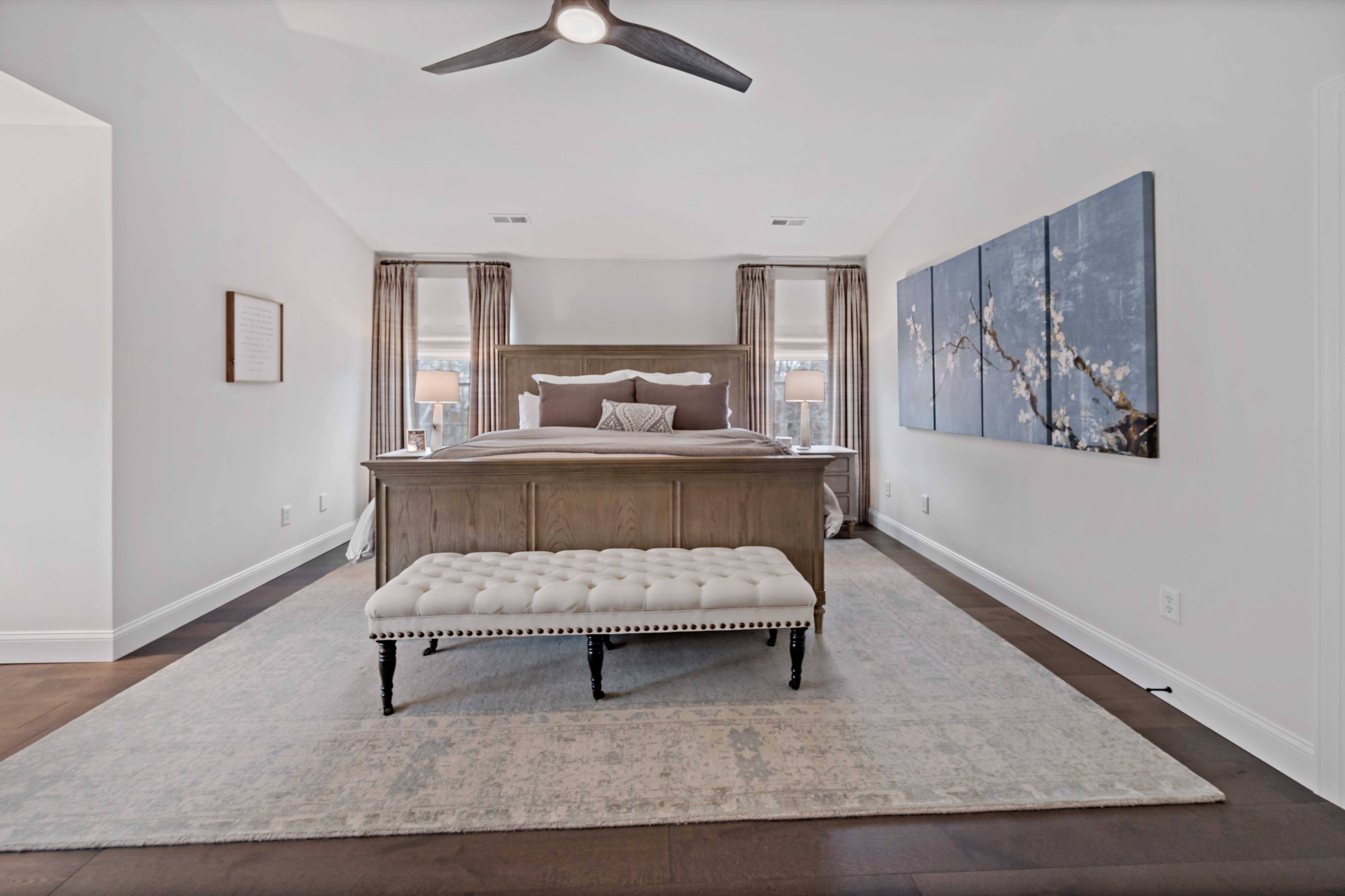 Master bedroom with area rug and ceiling fan