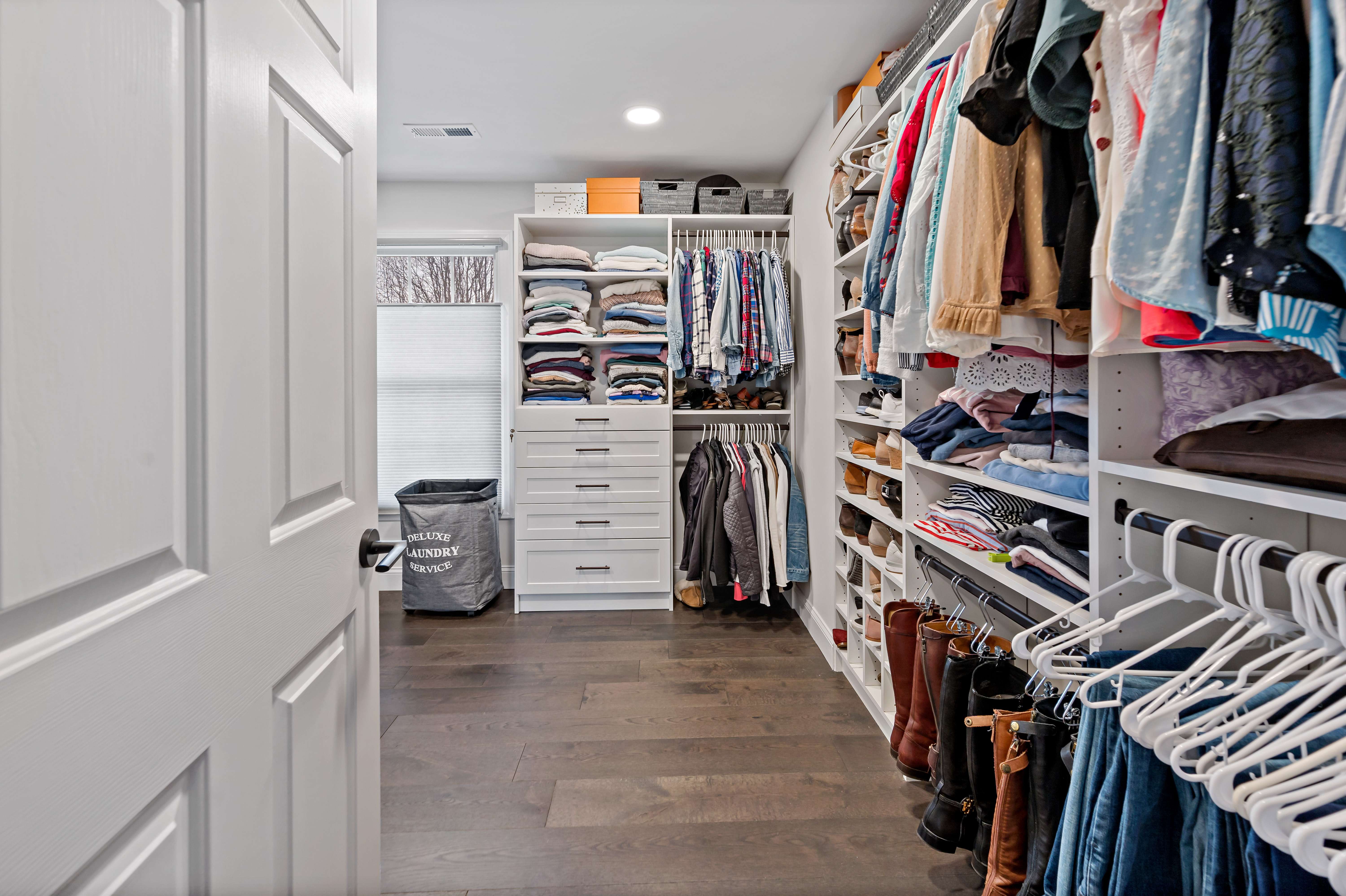 Large walk-in closet with built in rods and shelves