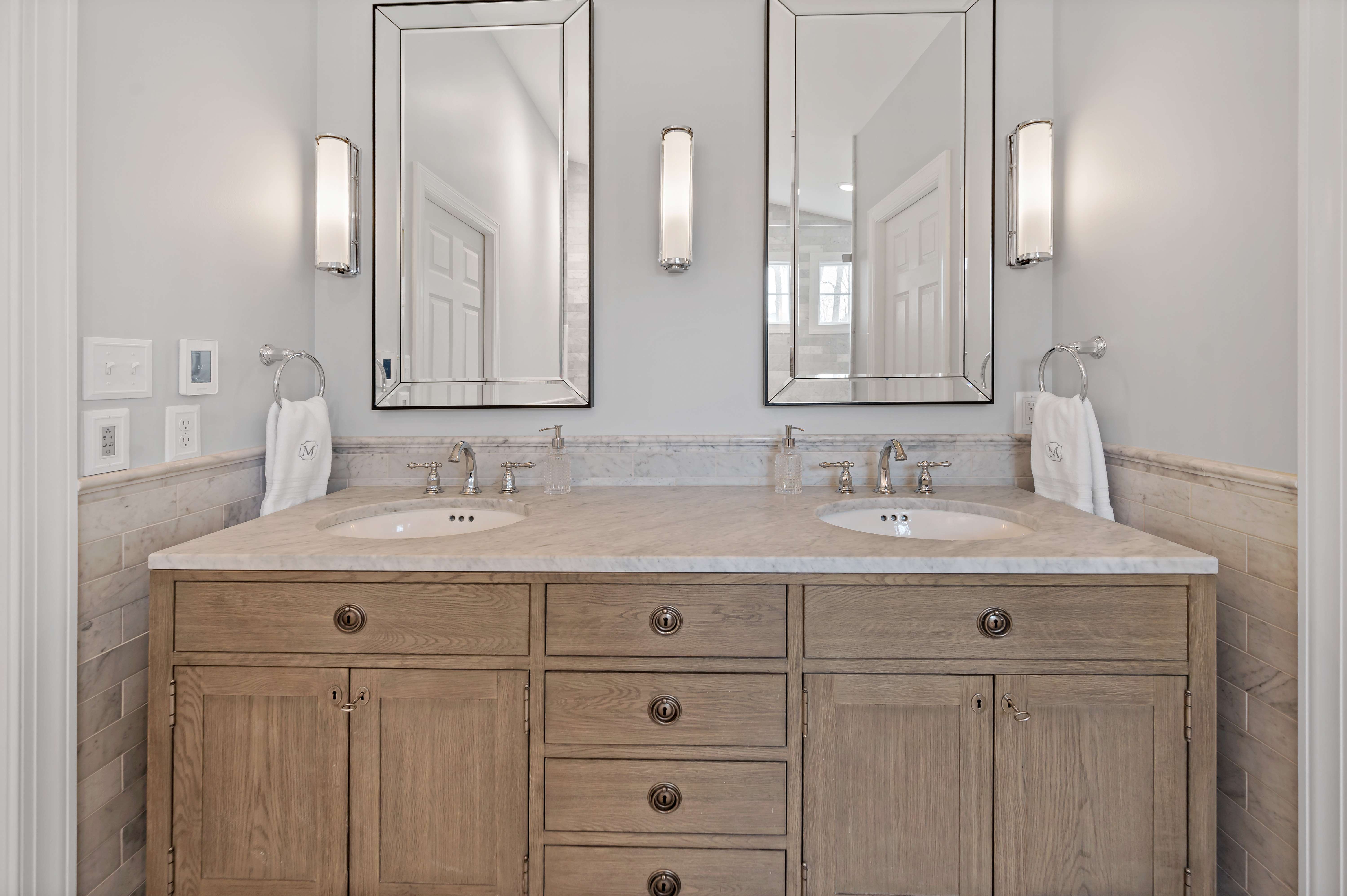 Double vanity and sink with beige cabinets in bathroom