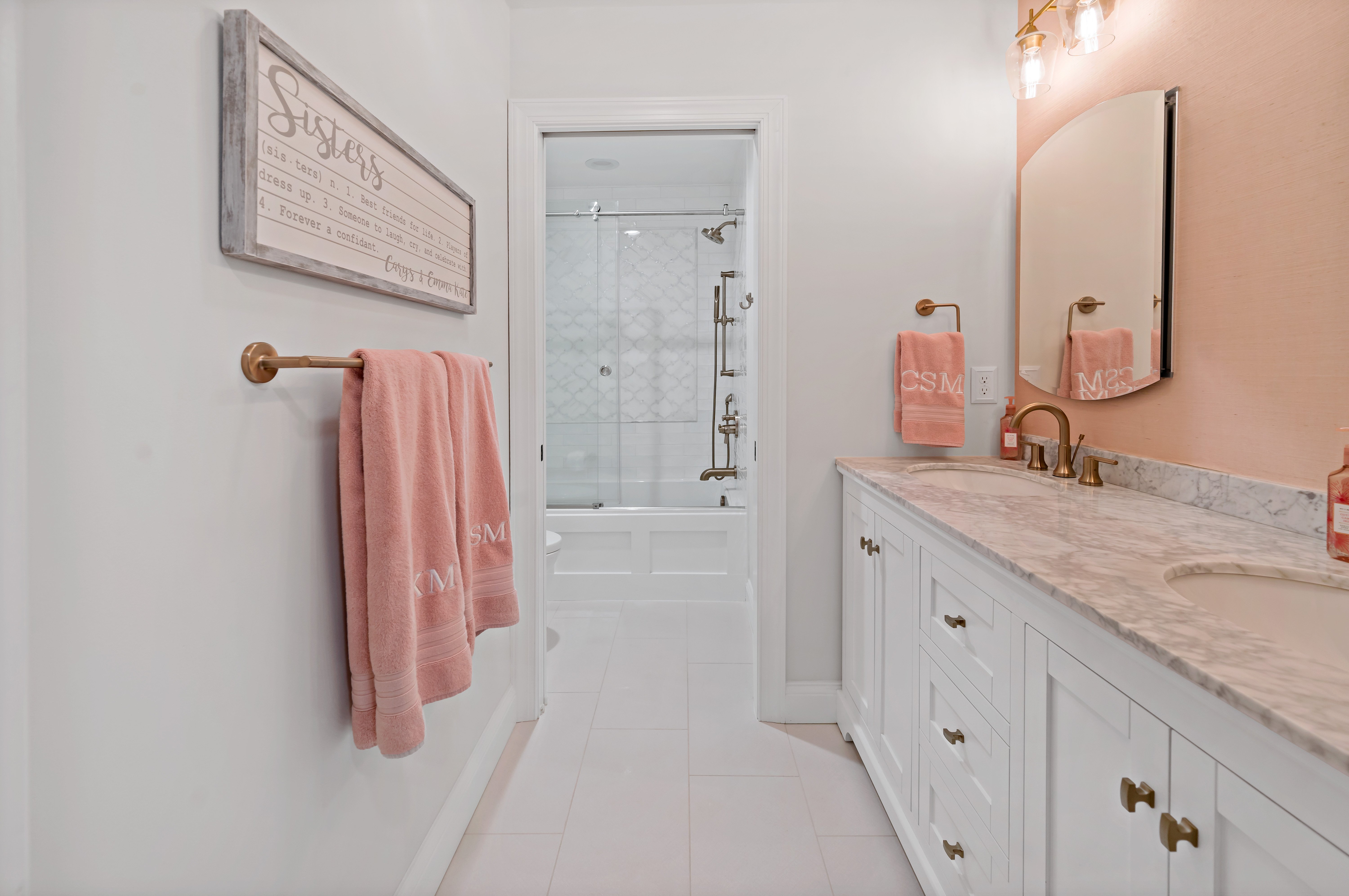 White bathroom with pink walls and countertop