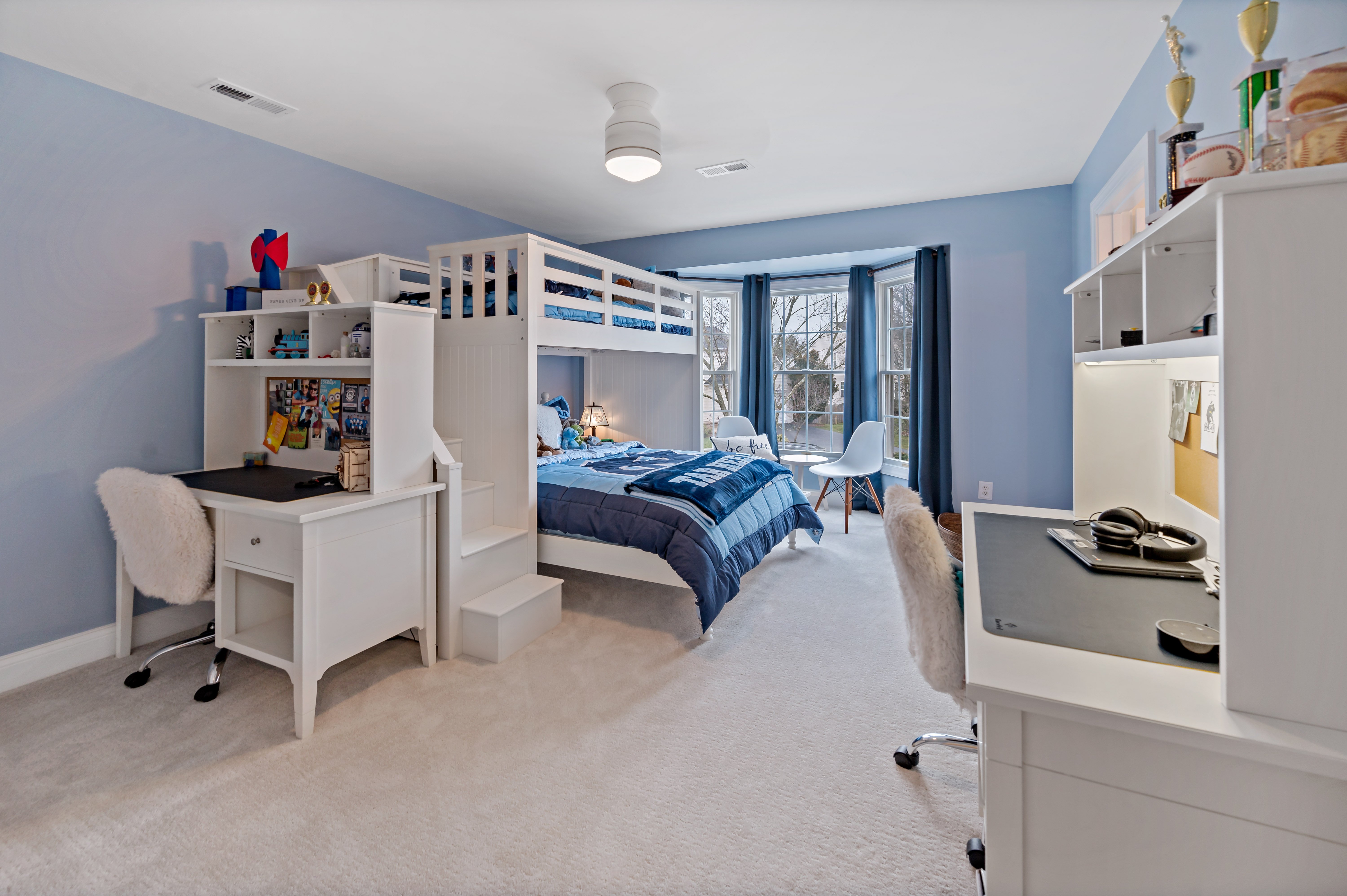 Carpeted bedroom with blue walls and white trim