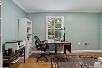 Home office with light blue walls and white ceiling