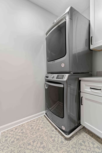 Laundry room with washer and dryer stacked