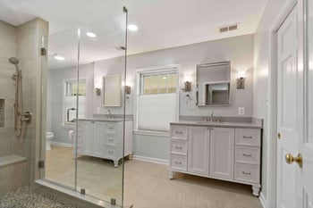 Two white bathroom vanities and cabinetry