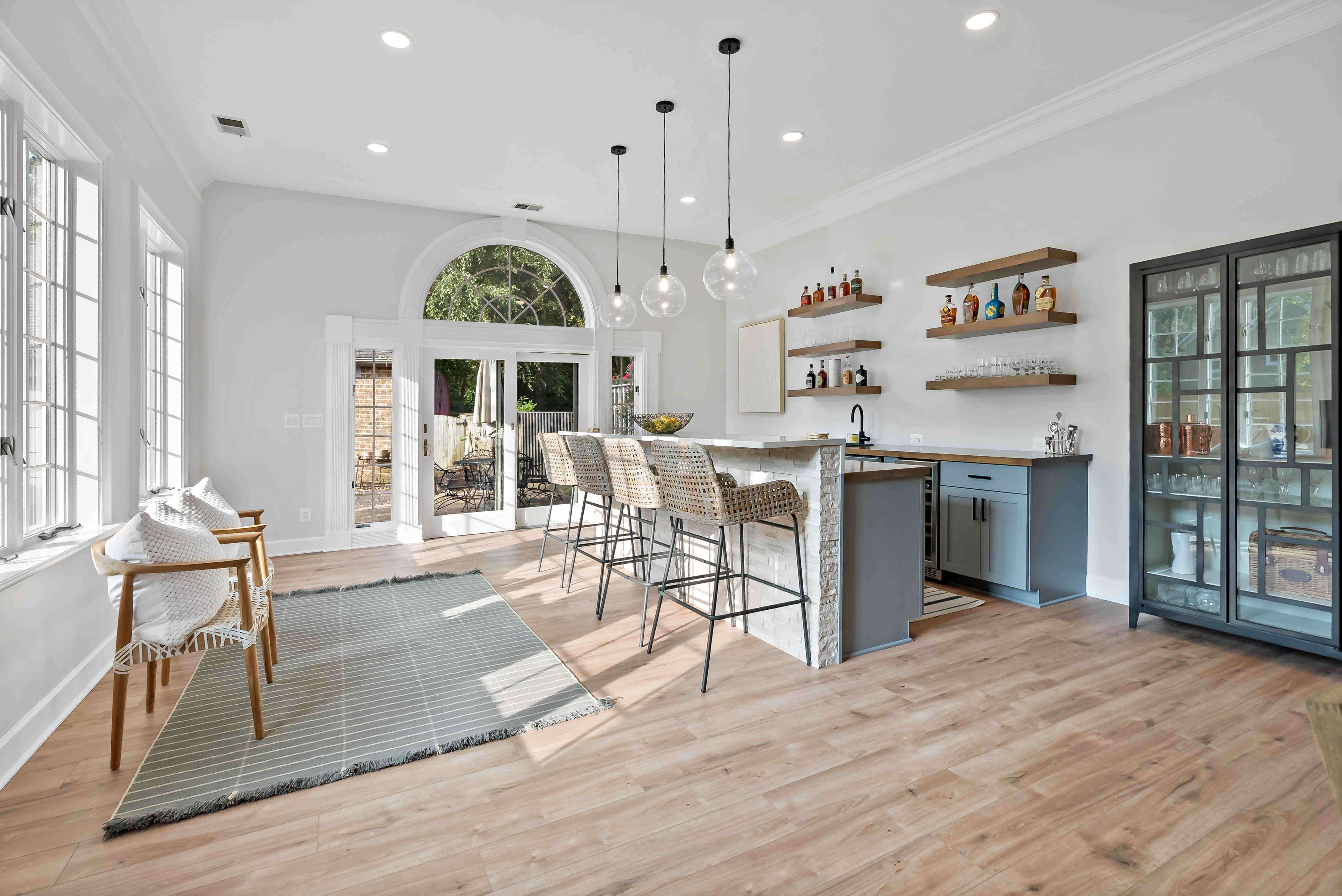 Hard wood flooring in open room with bar