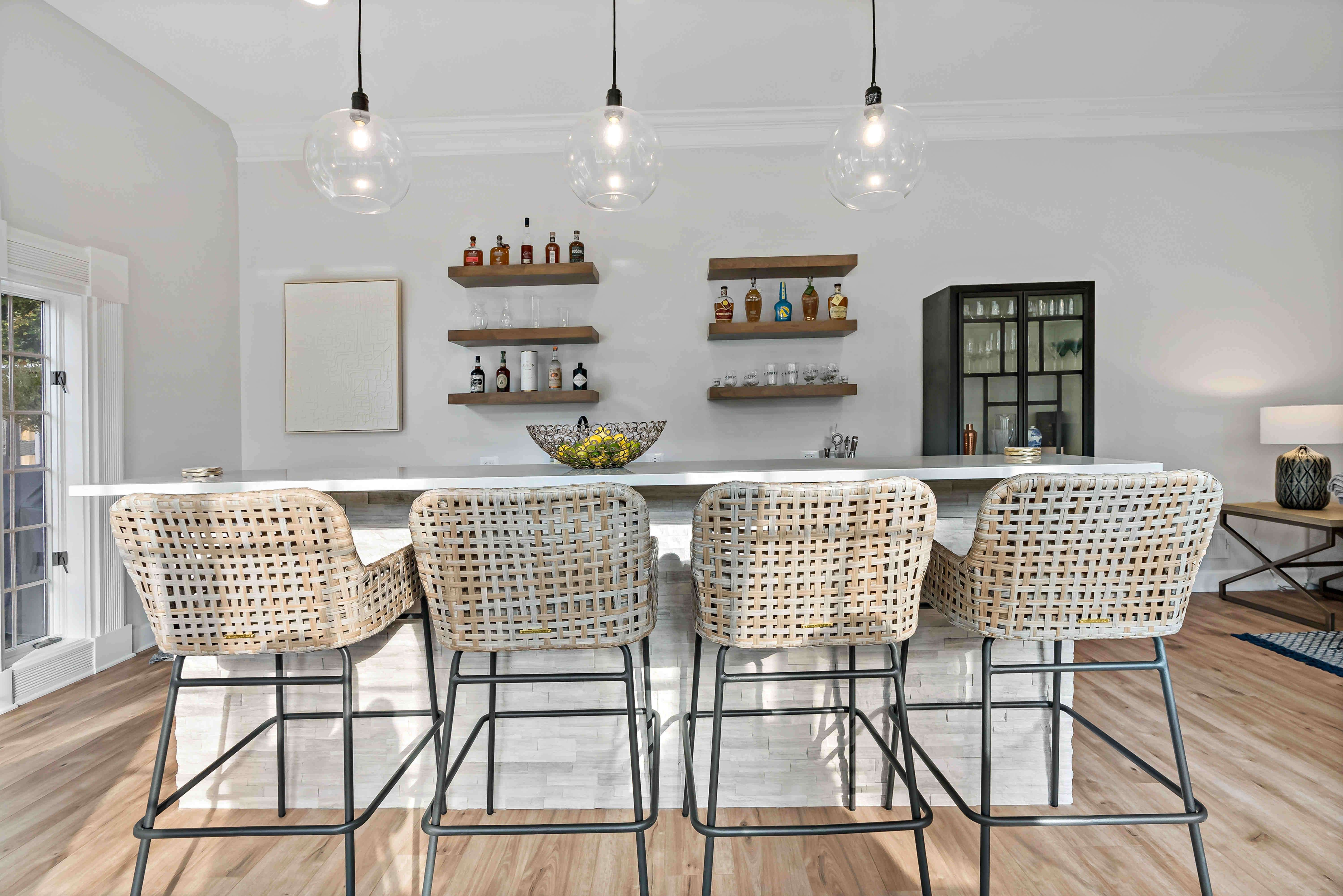 Floating shelves on walls behind bar in home