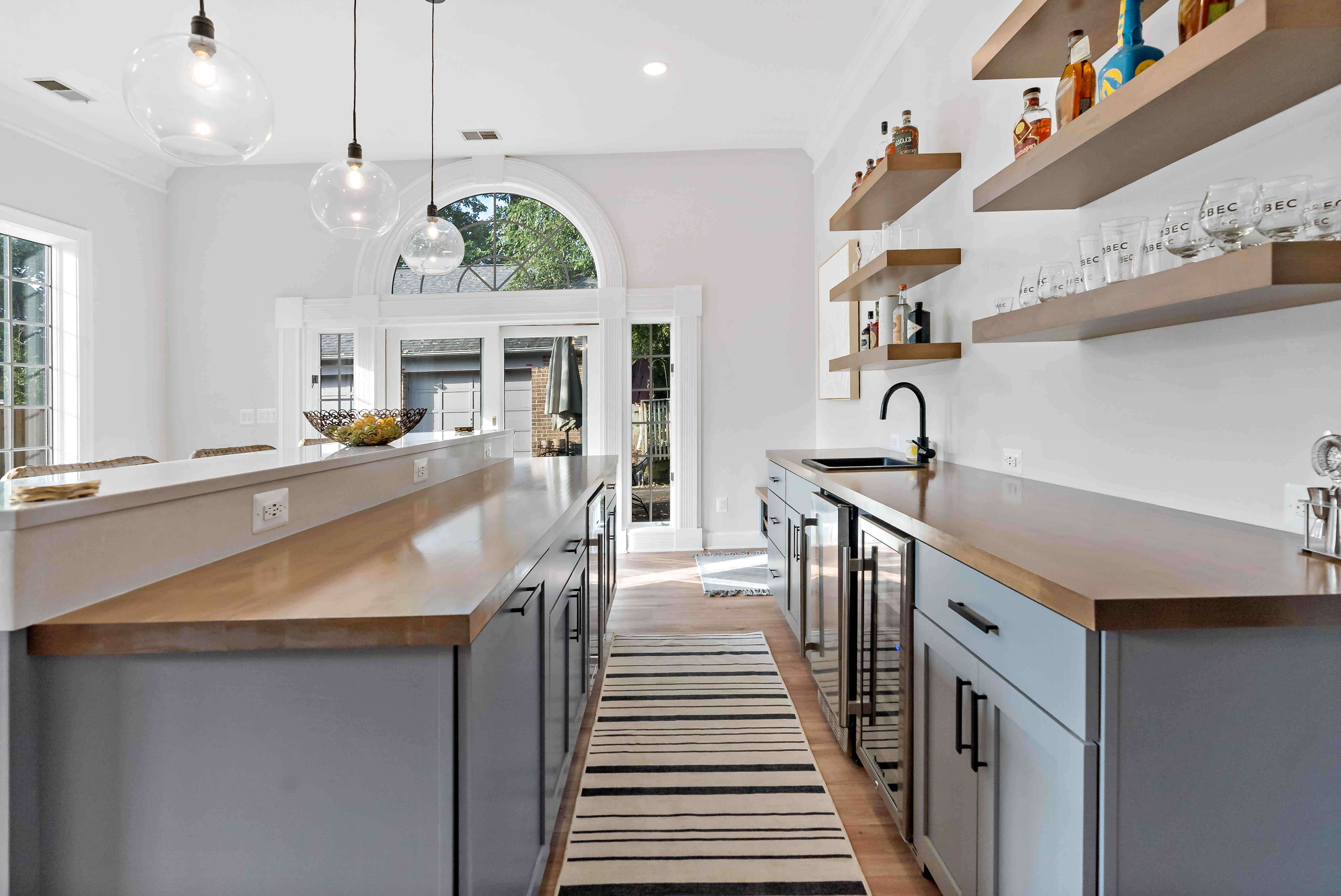 Brown countertops and black handles in home bar area