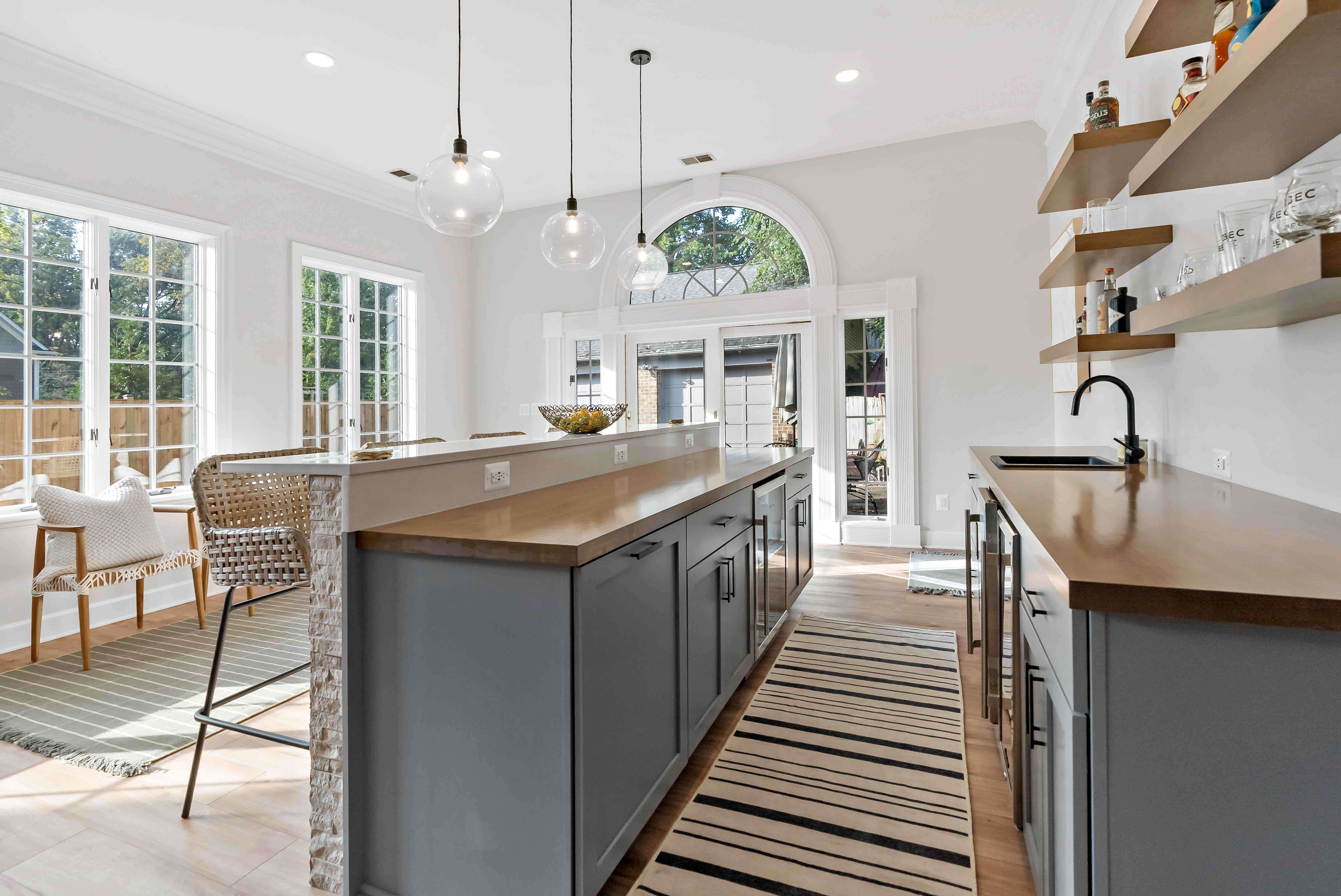 Blue cabinets and brown countertops in home bar