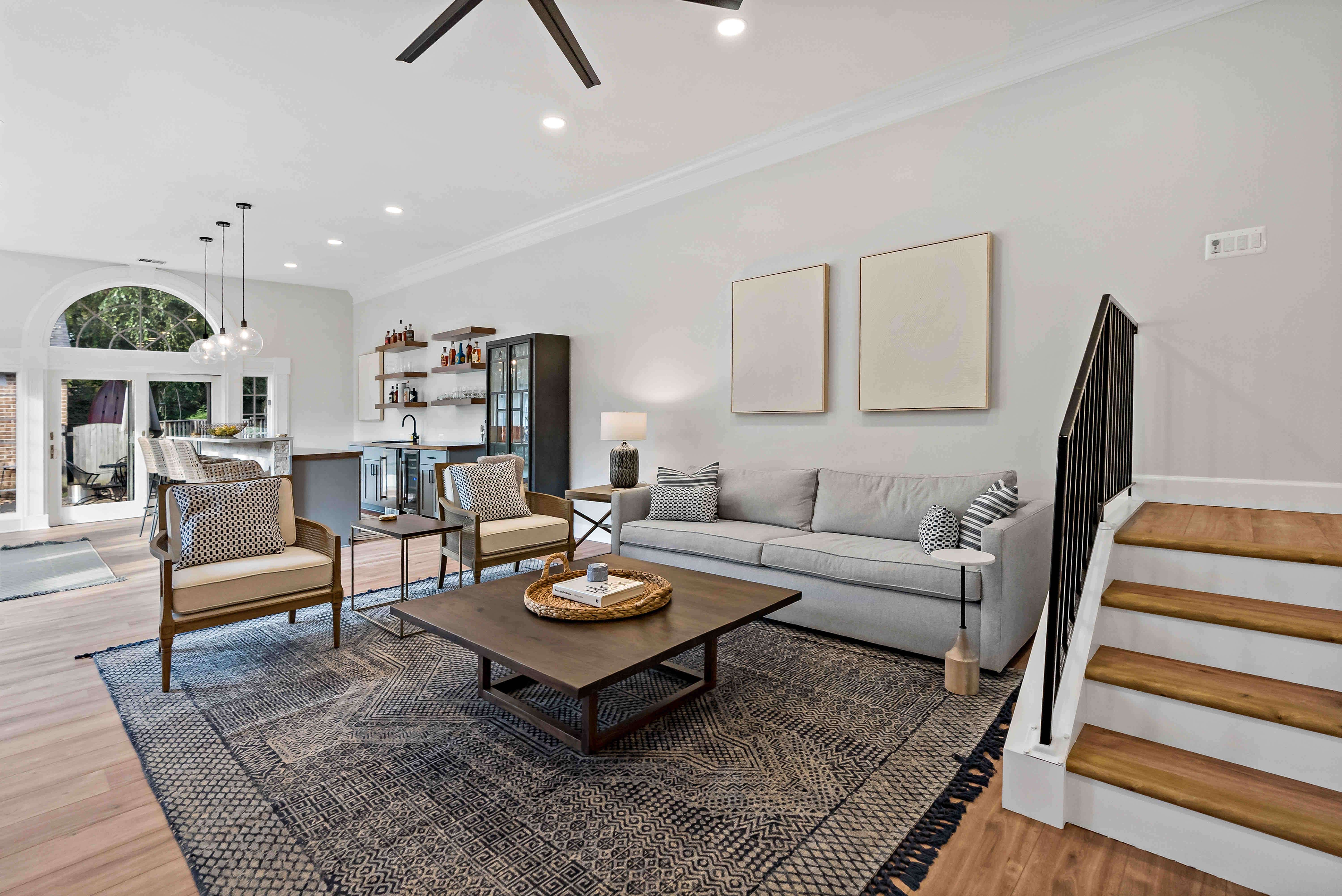Stairs leading to living room with white walls