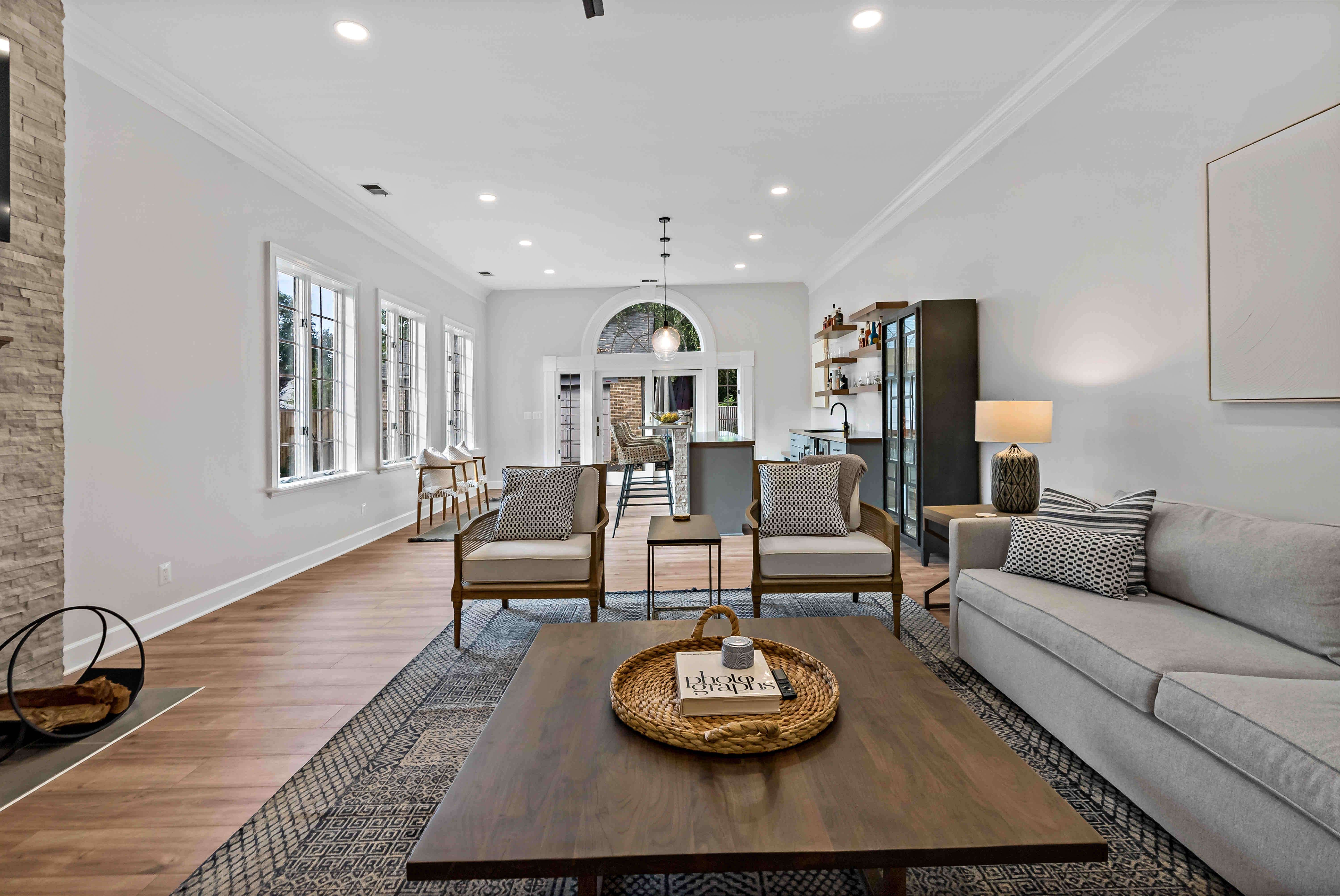 Hard wood floors and open concept with living space and bar