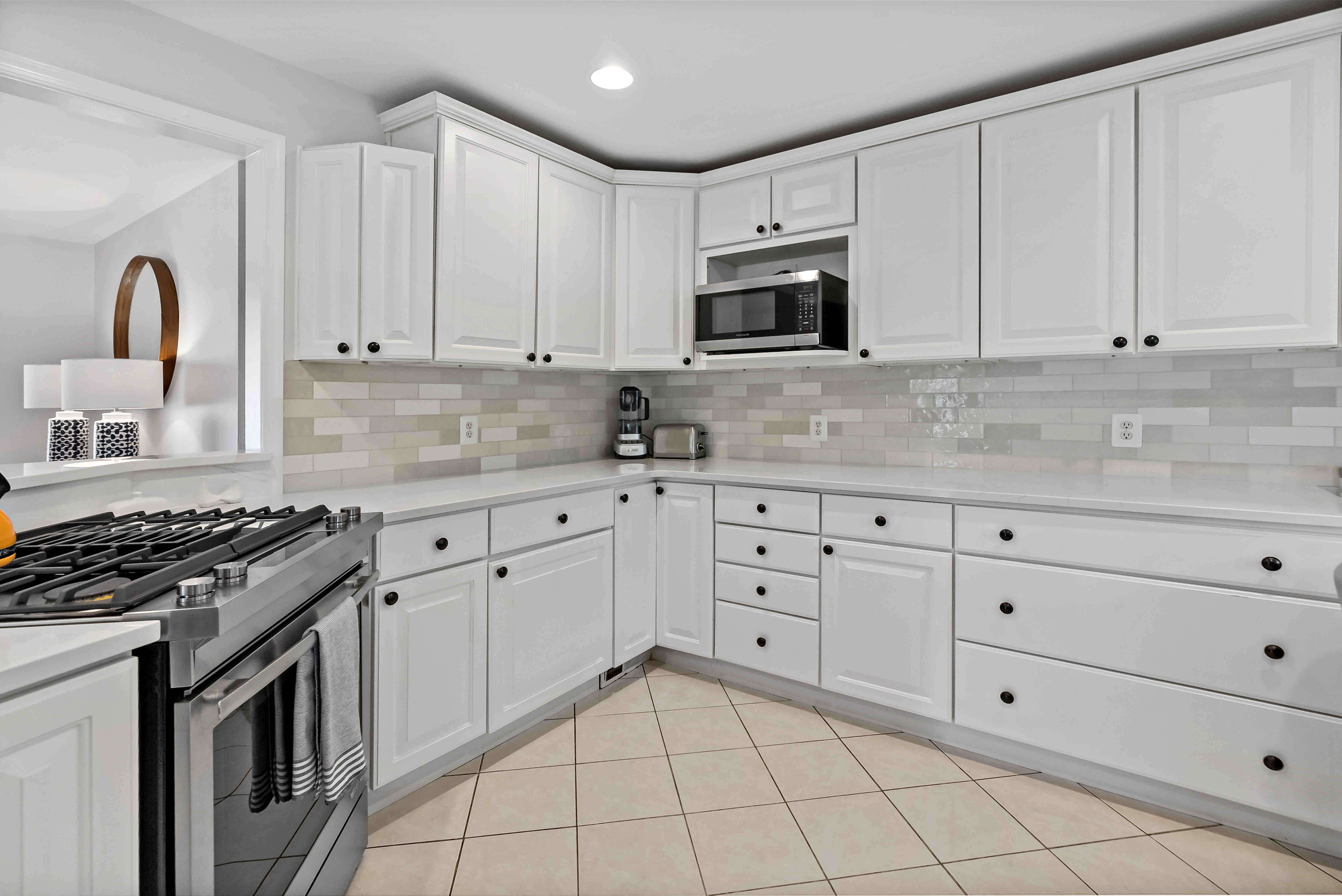 White kitchen cabinets and black handles