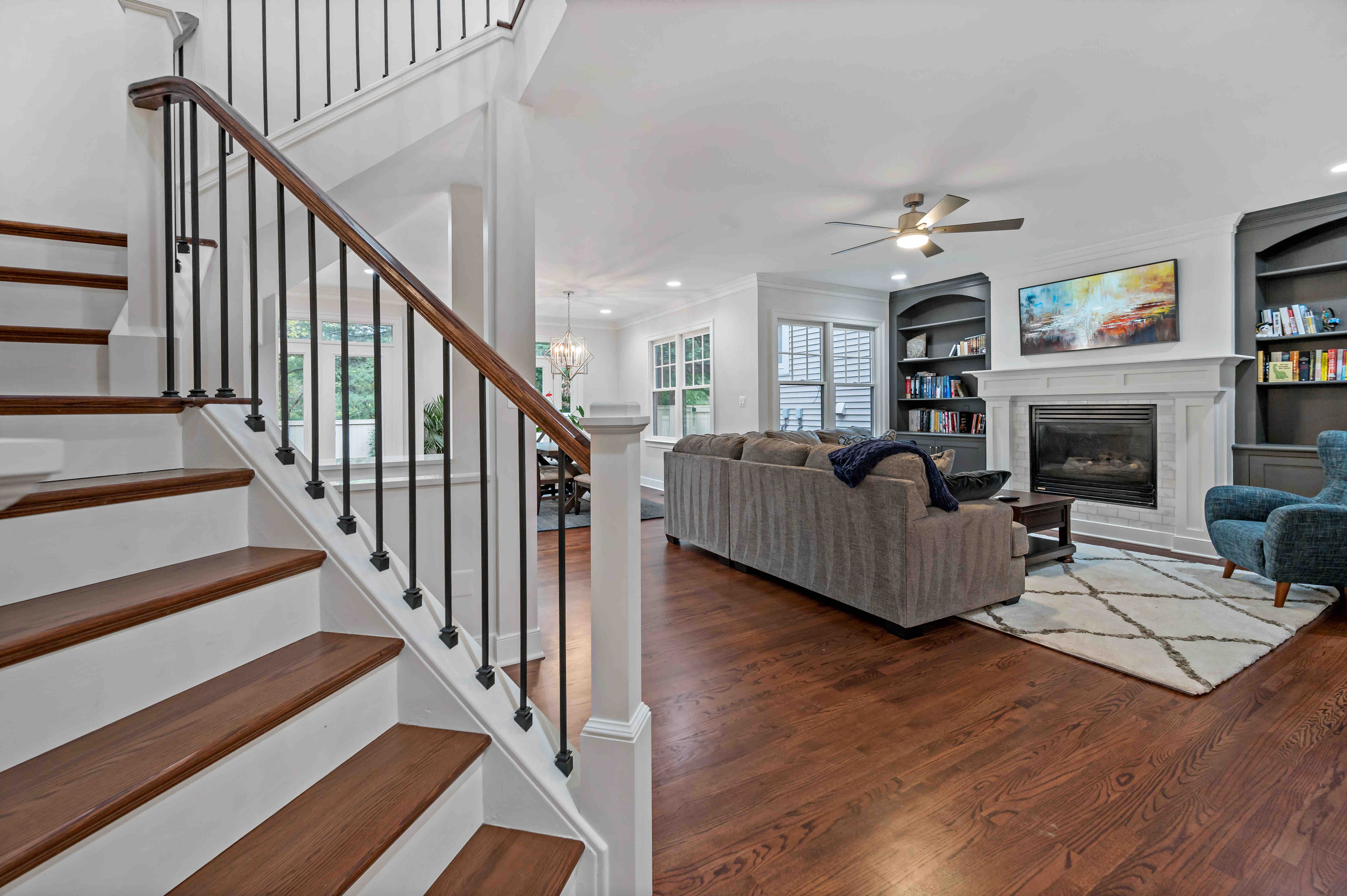 Large open living room with curved stairwell