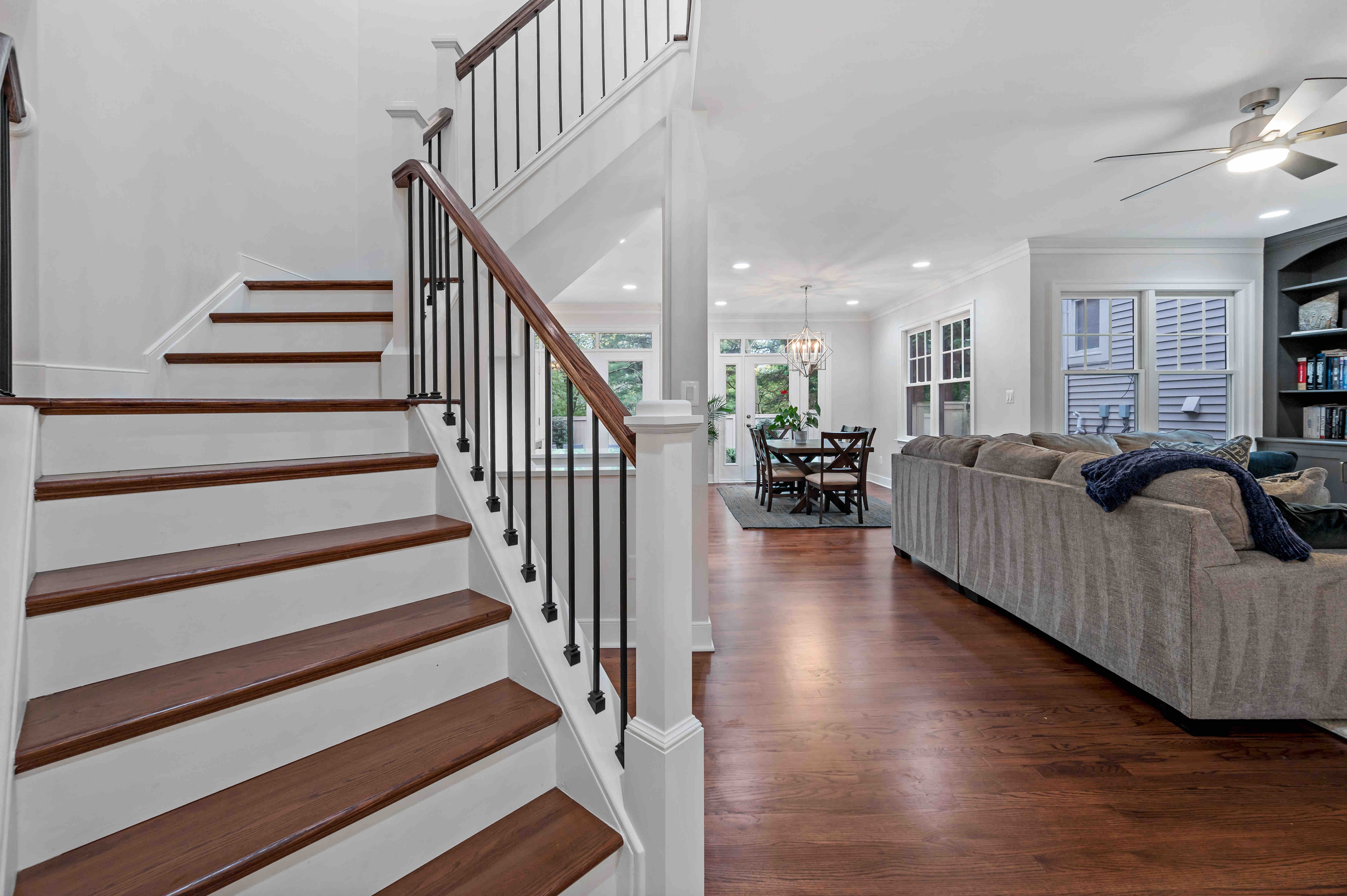 White and brown curved staircase going upstairs