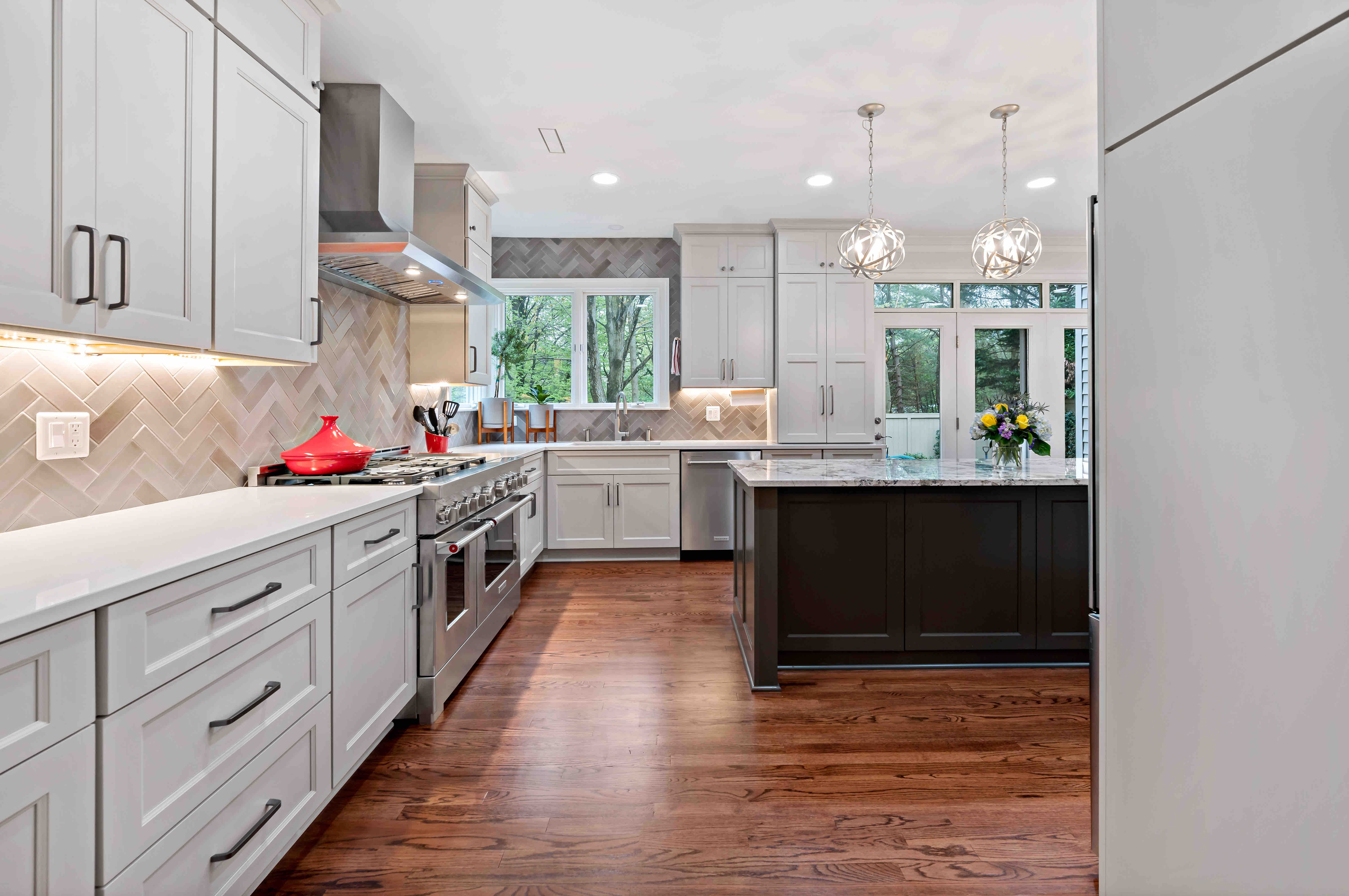 Beige backsplash and pendant lighting above kitchen island