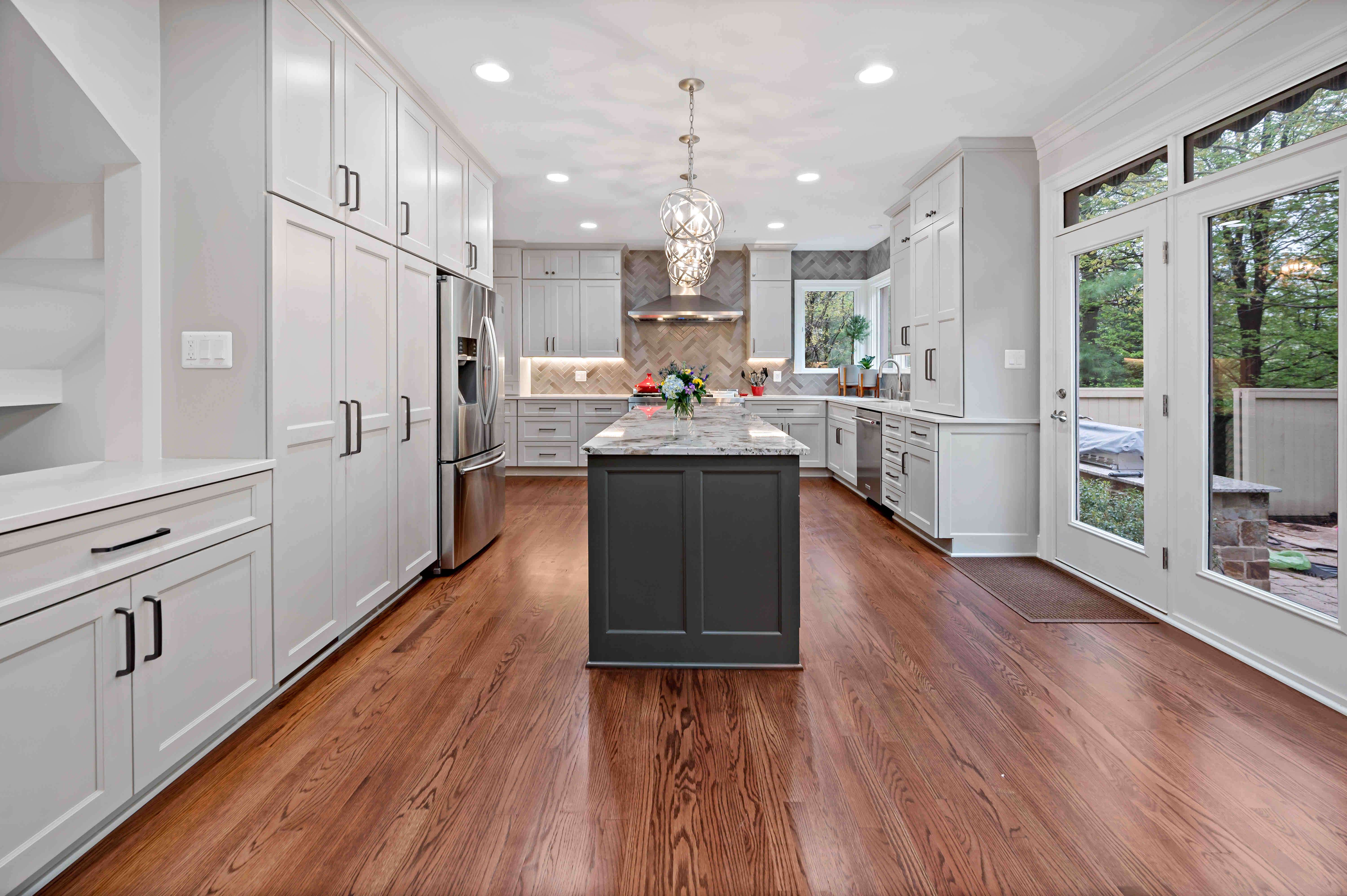 Hardwood floors kitchen with dark colored island