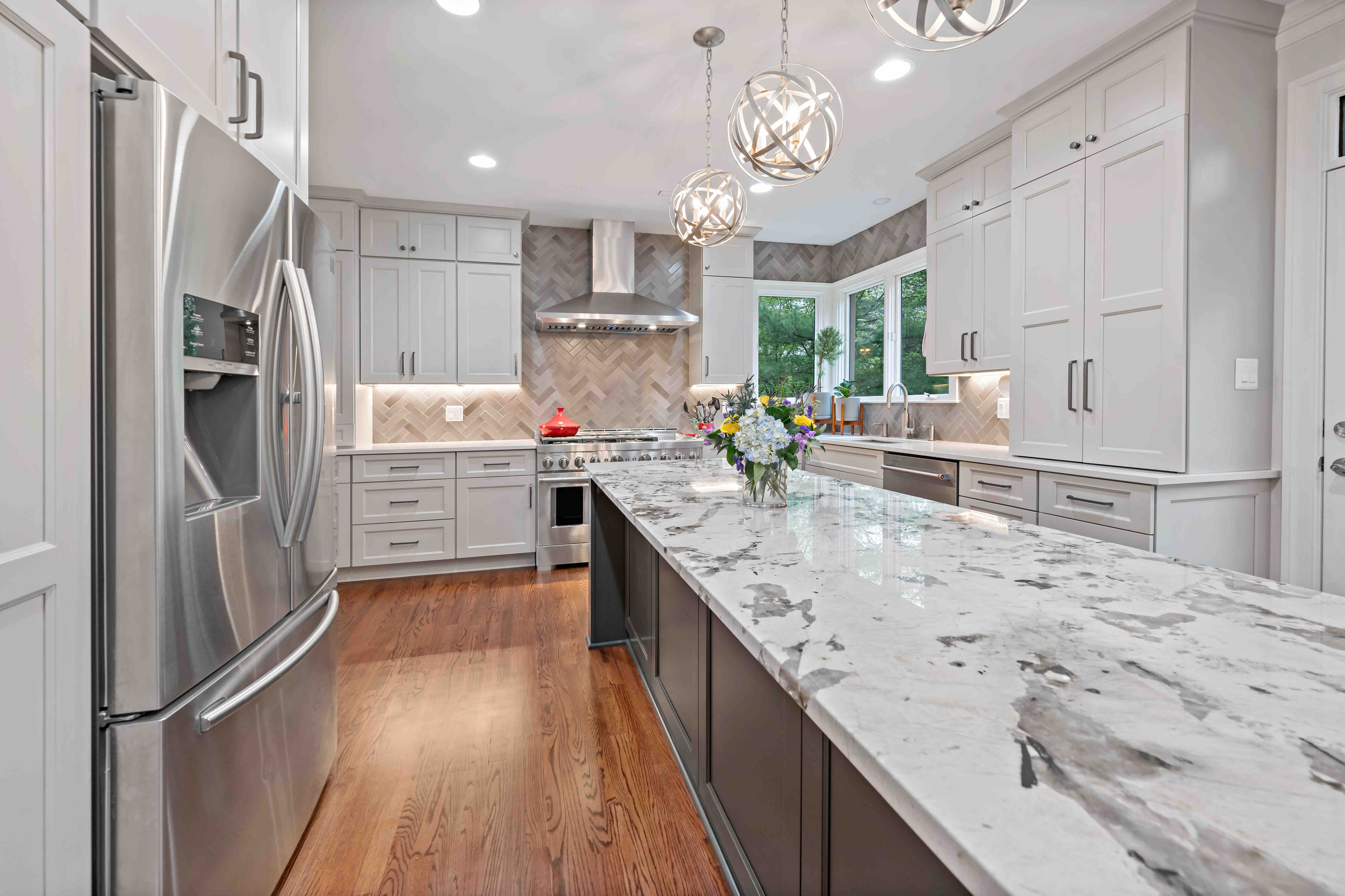 White cabinets and marble countertops in kitchen