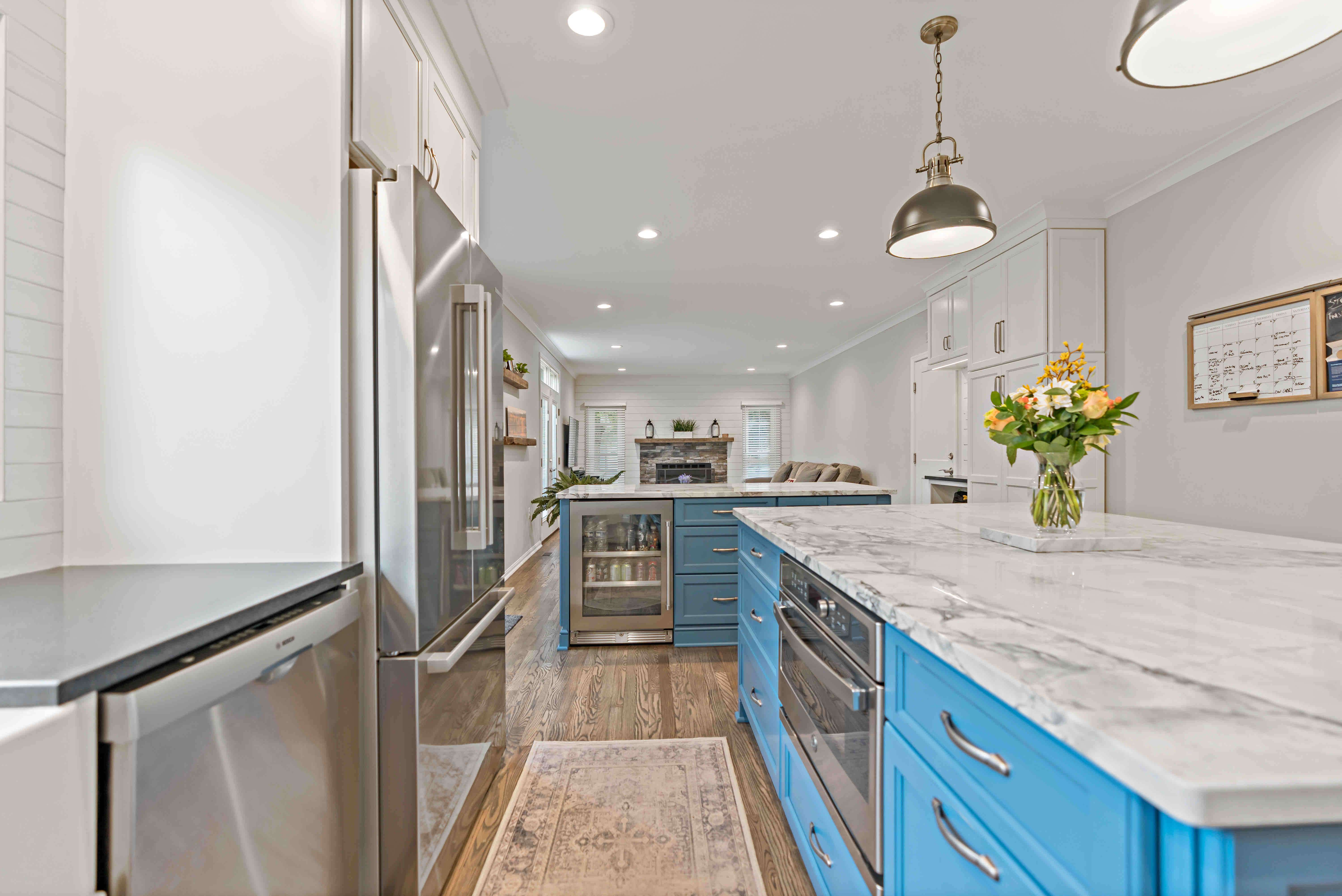 Silver appliances in white and blue kitchen