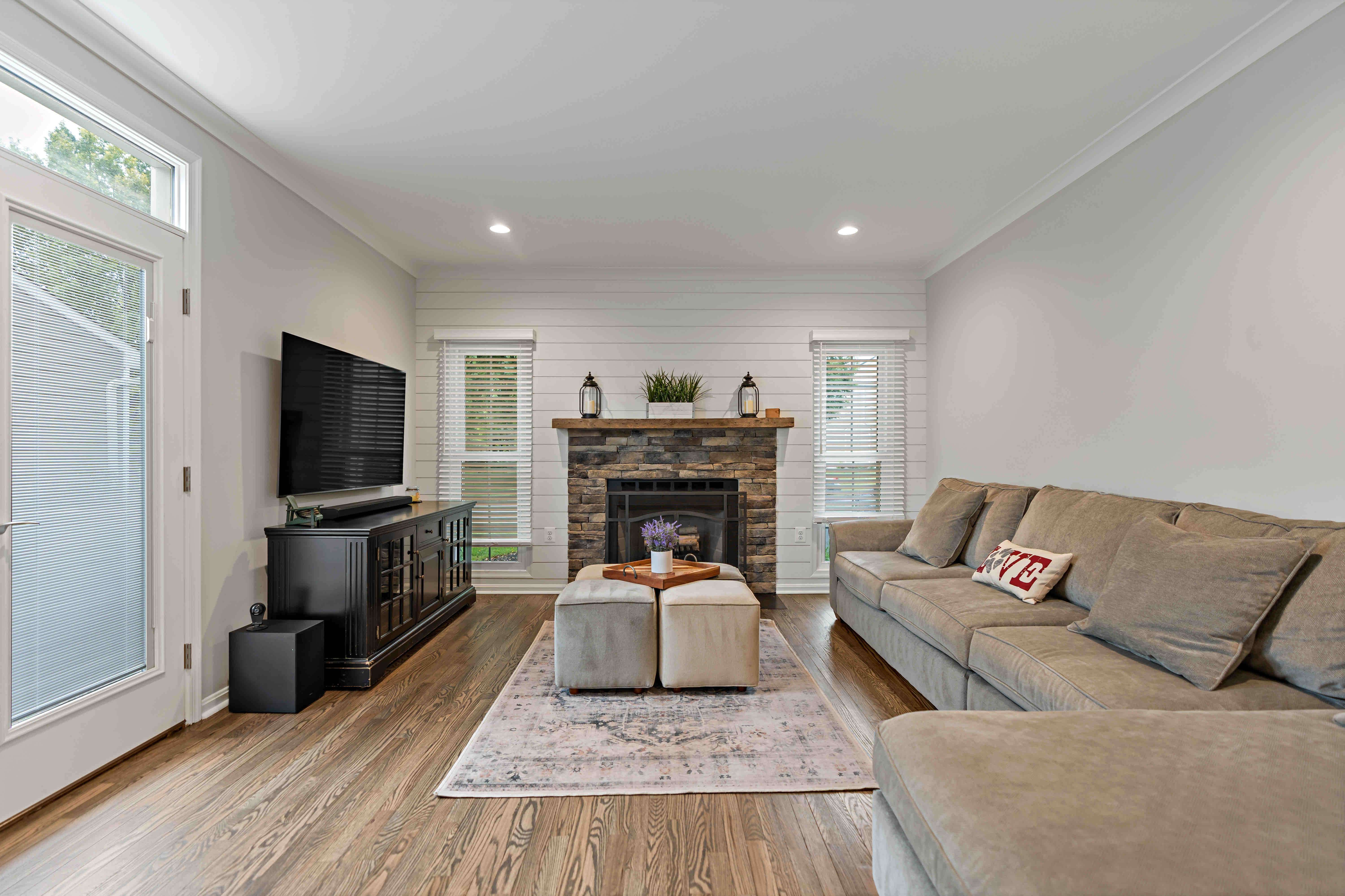 White walls in living room with brown fireplace