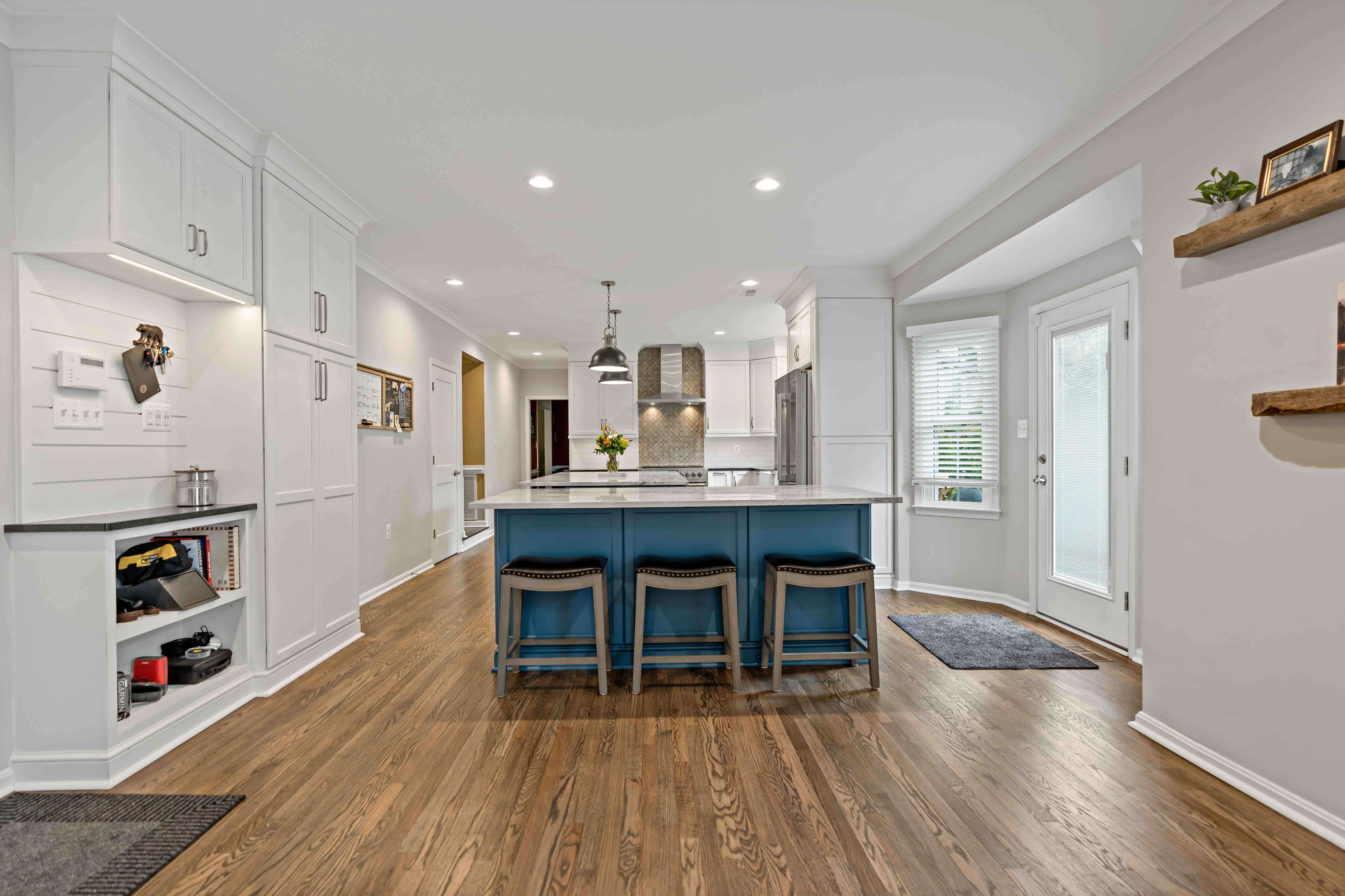 Hard wood floors in spacious all white kitchen remodel