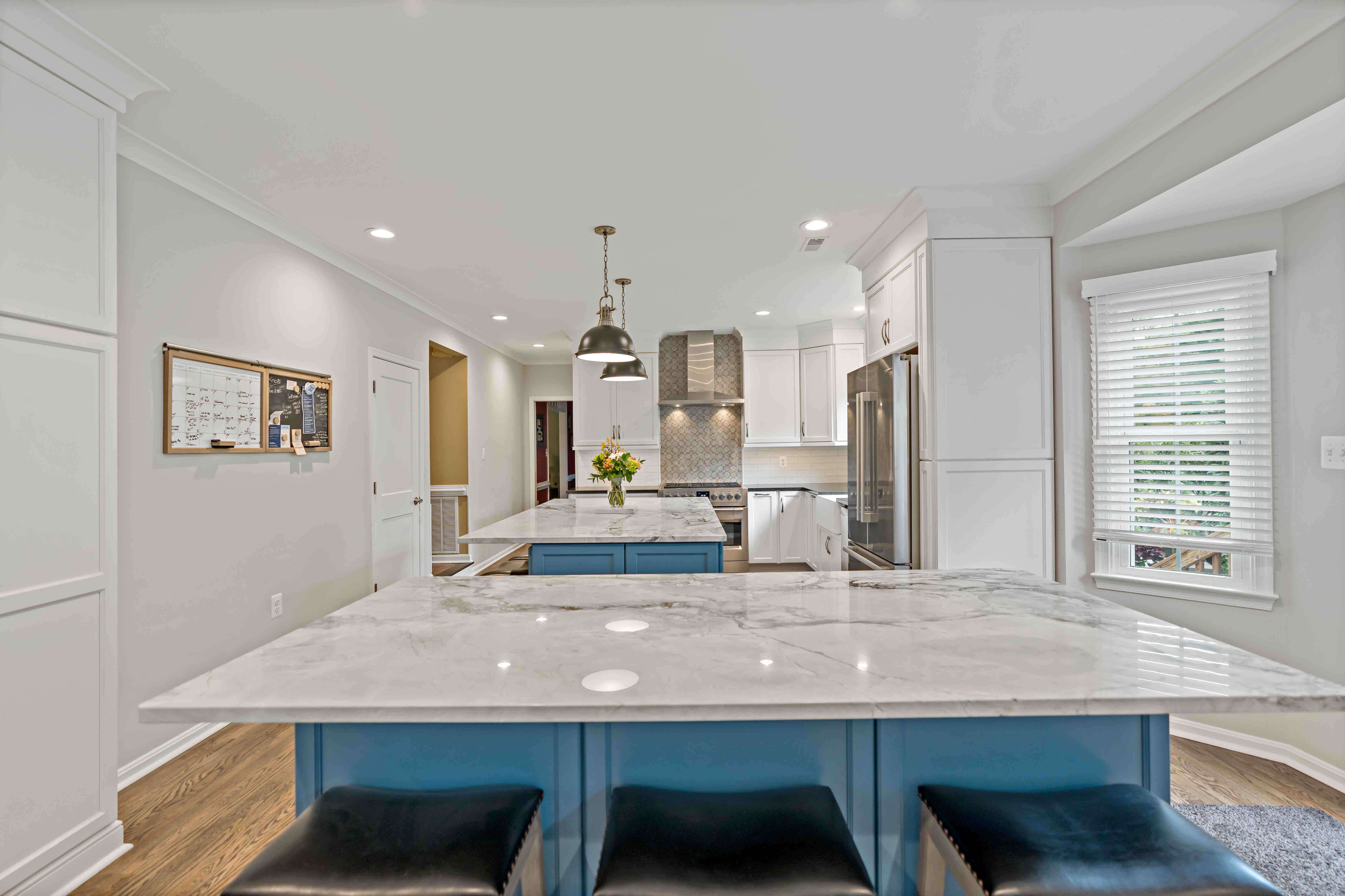 Two rectangular kitchen islands in long kitchen