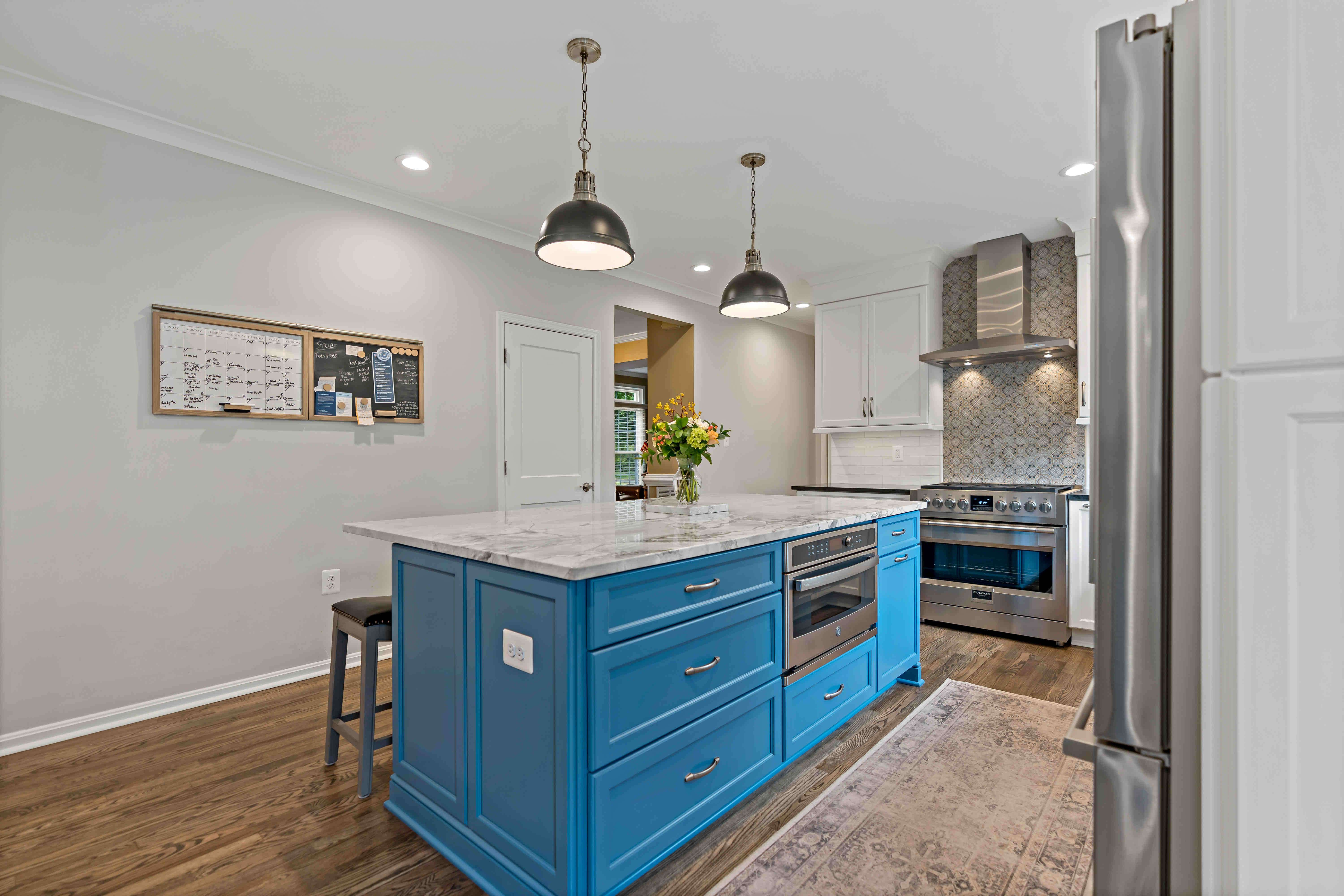 Blue kitchen island with drawers and seating