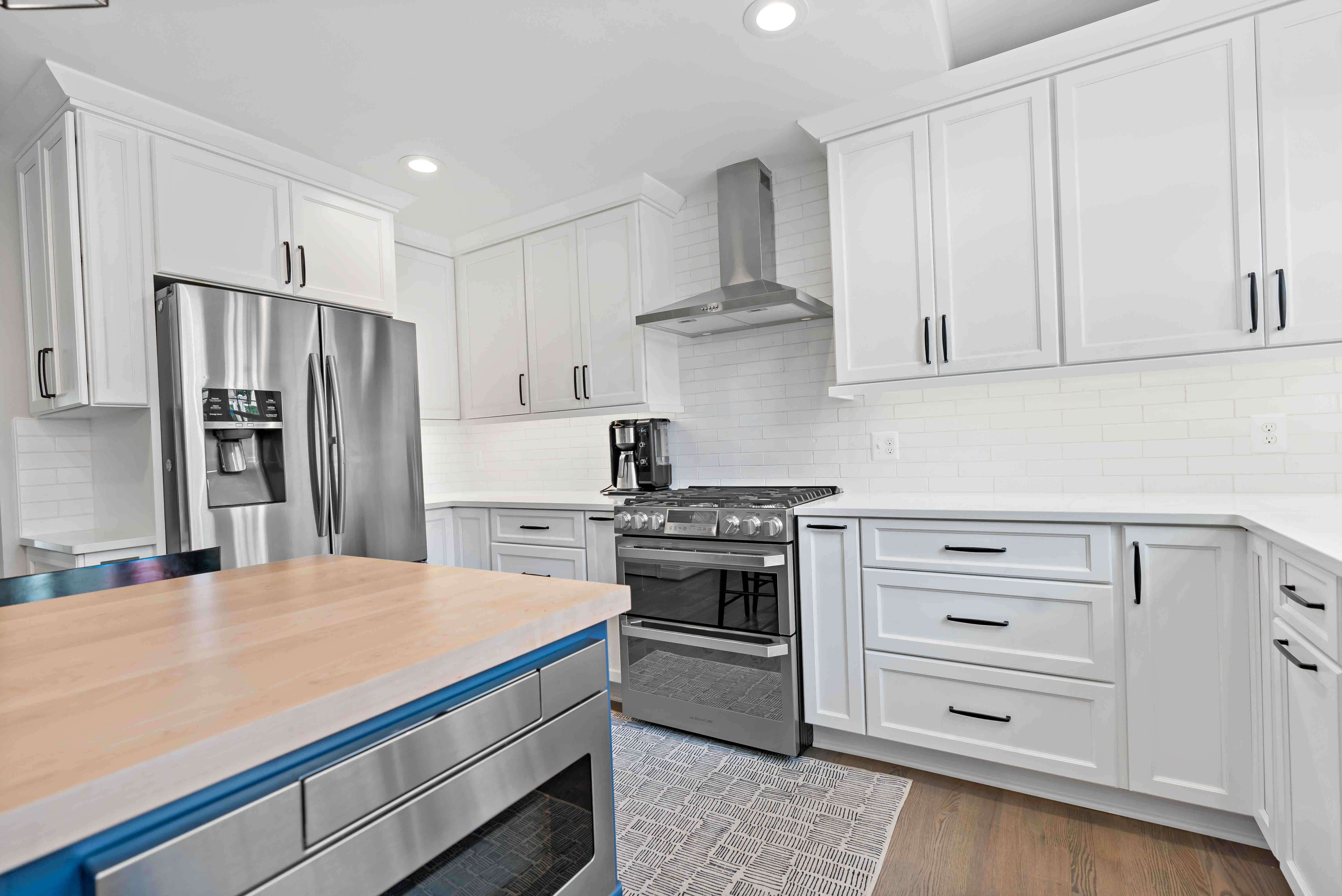 All white kitchen cabinets with silver appliances