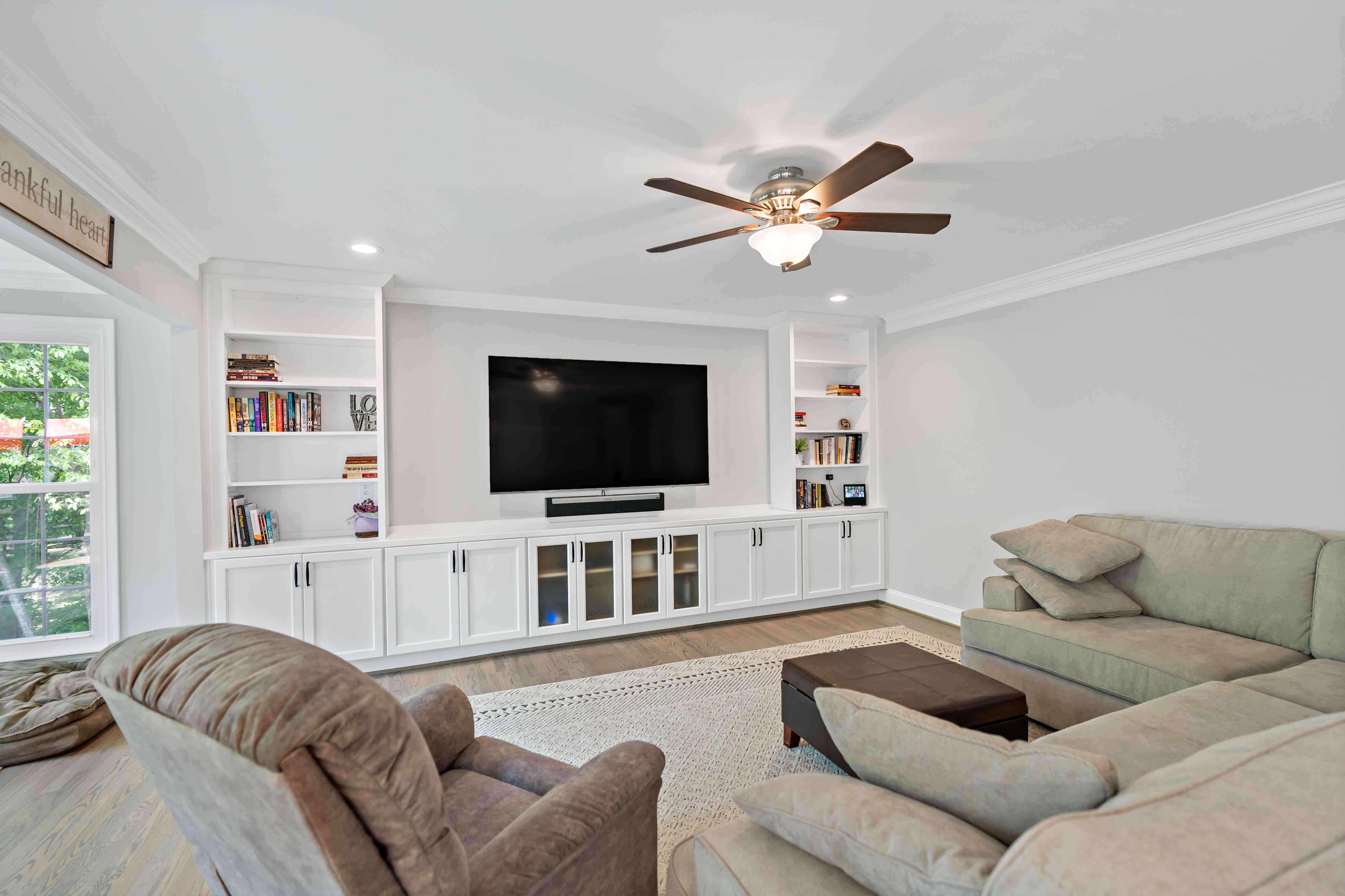 Ceiling fan in living room with built in shelves
