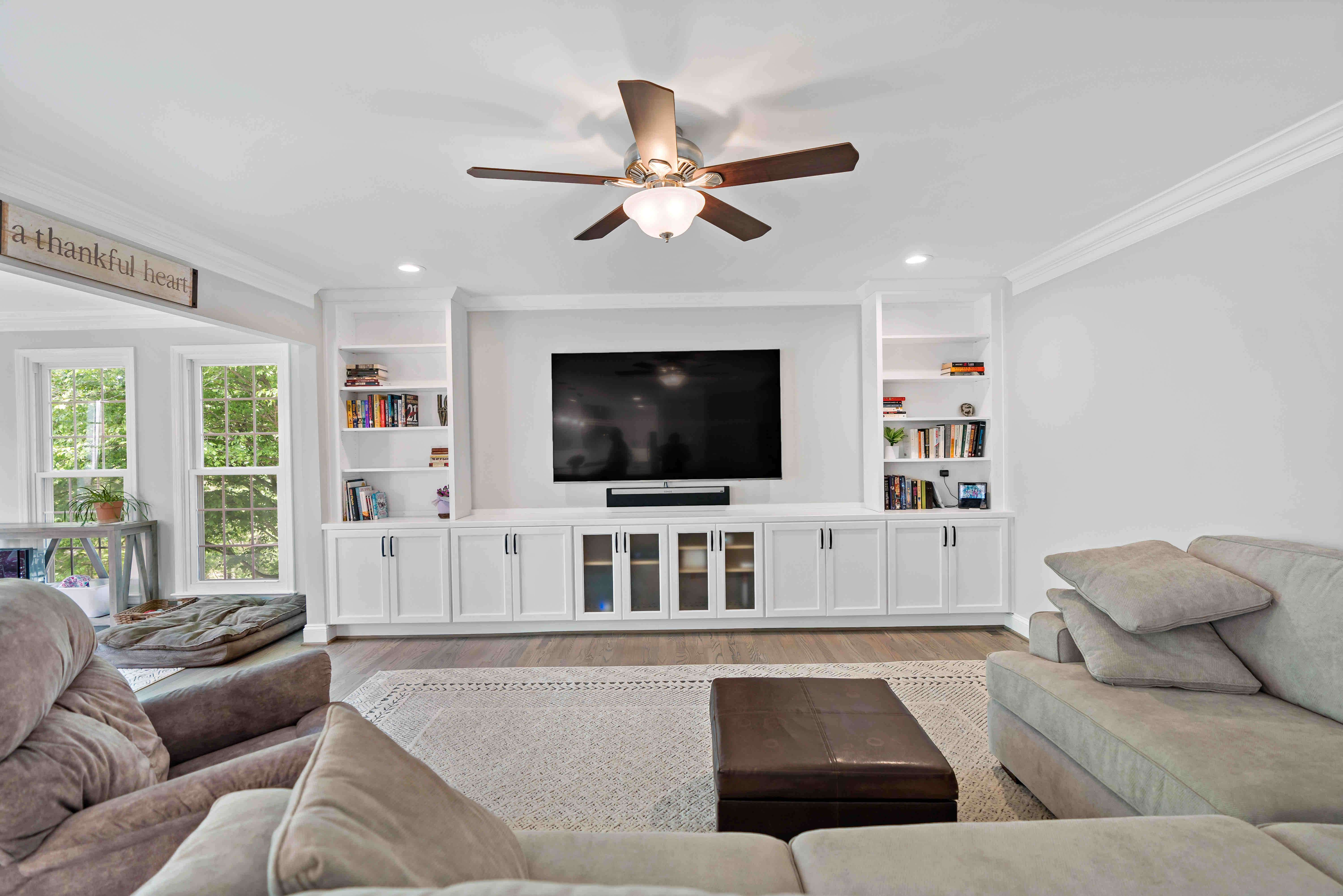White built-in shelves entertainment system in living room