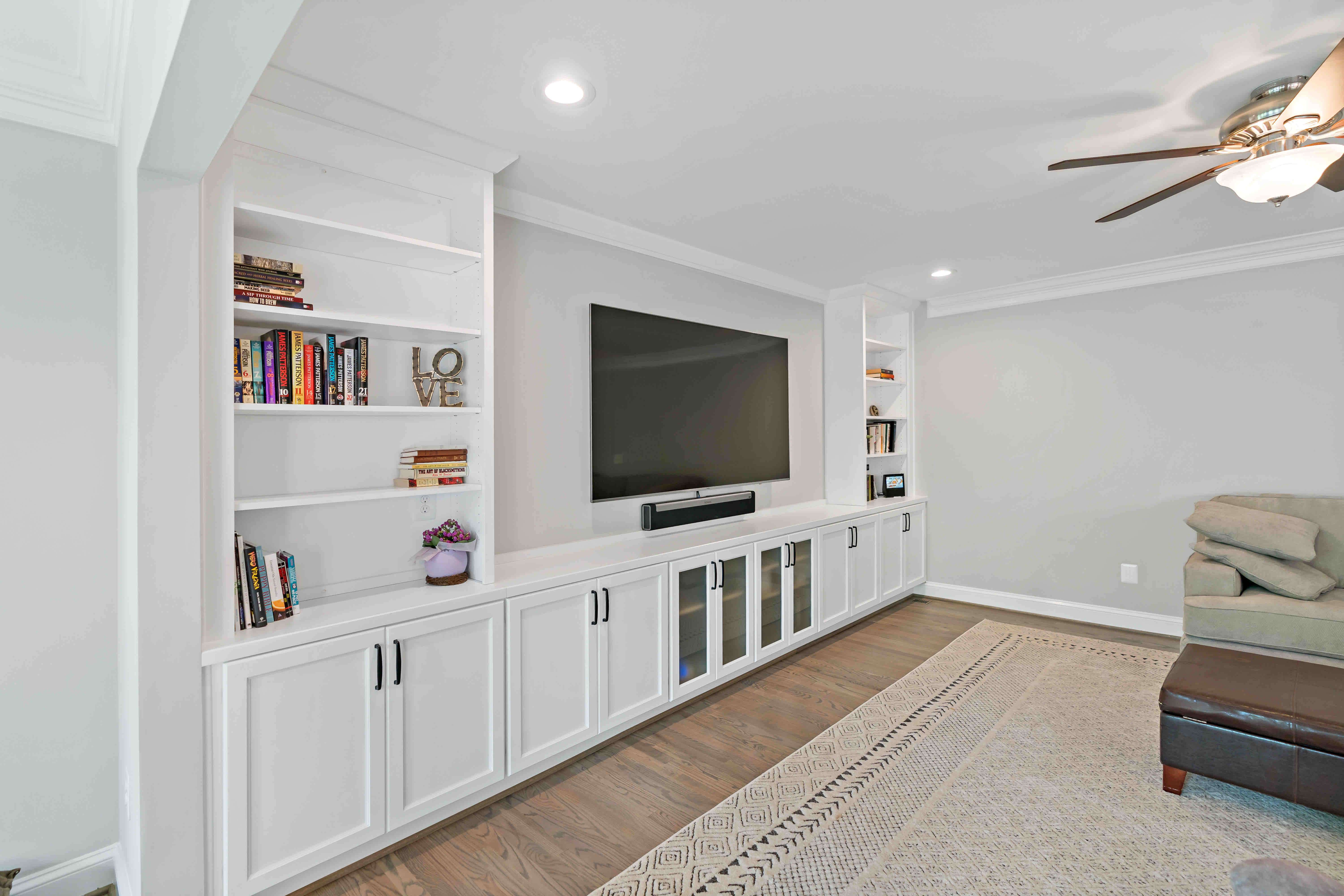 Built in white entertainment system with shelves