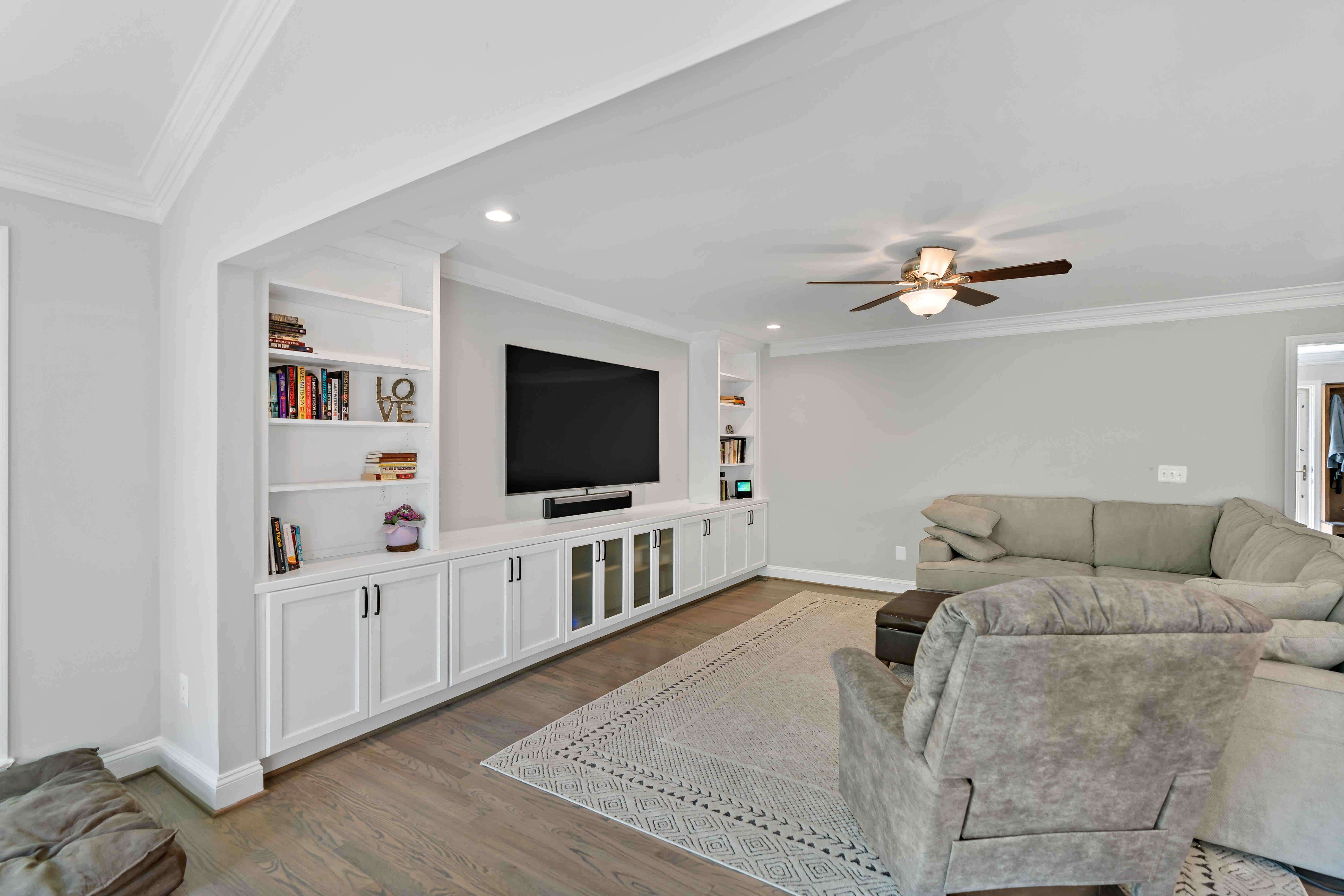Living room with white walls and ceiling fan
