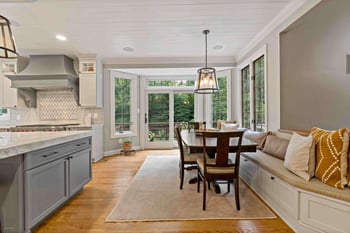 Kitchen table with breakfast nook bench overlooking patio