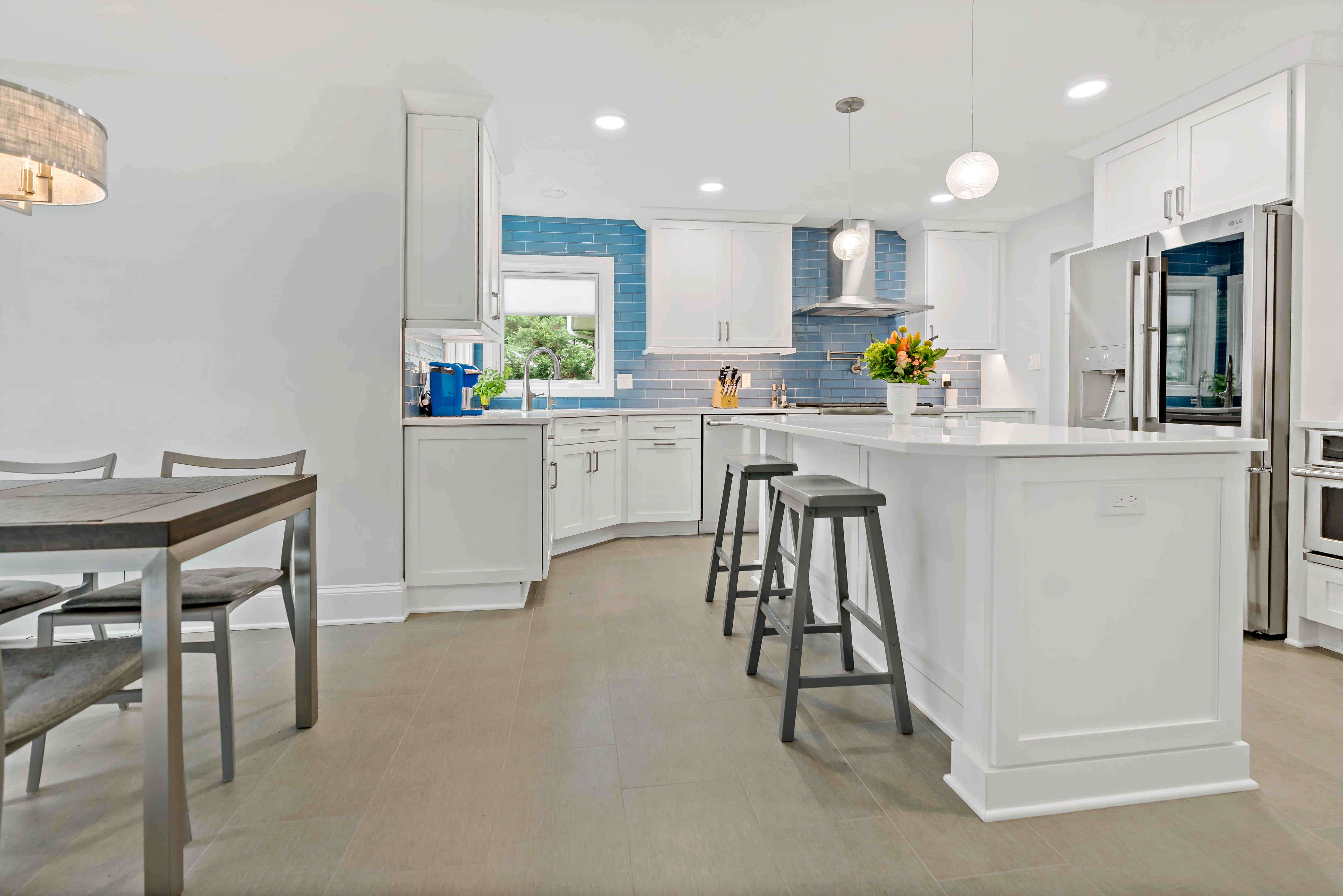 Beige tile flooring in spacious white kitchen