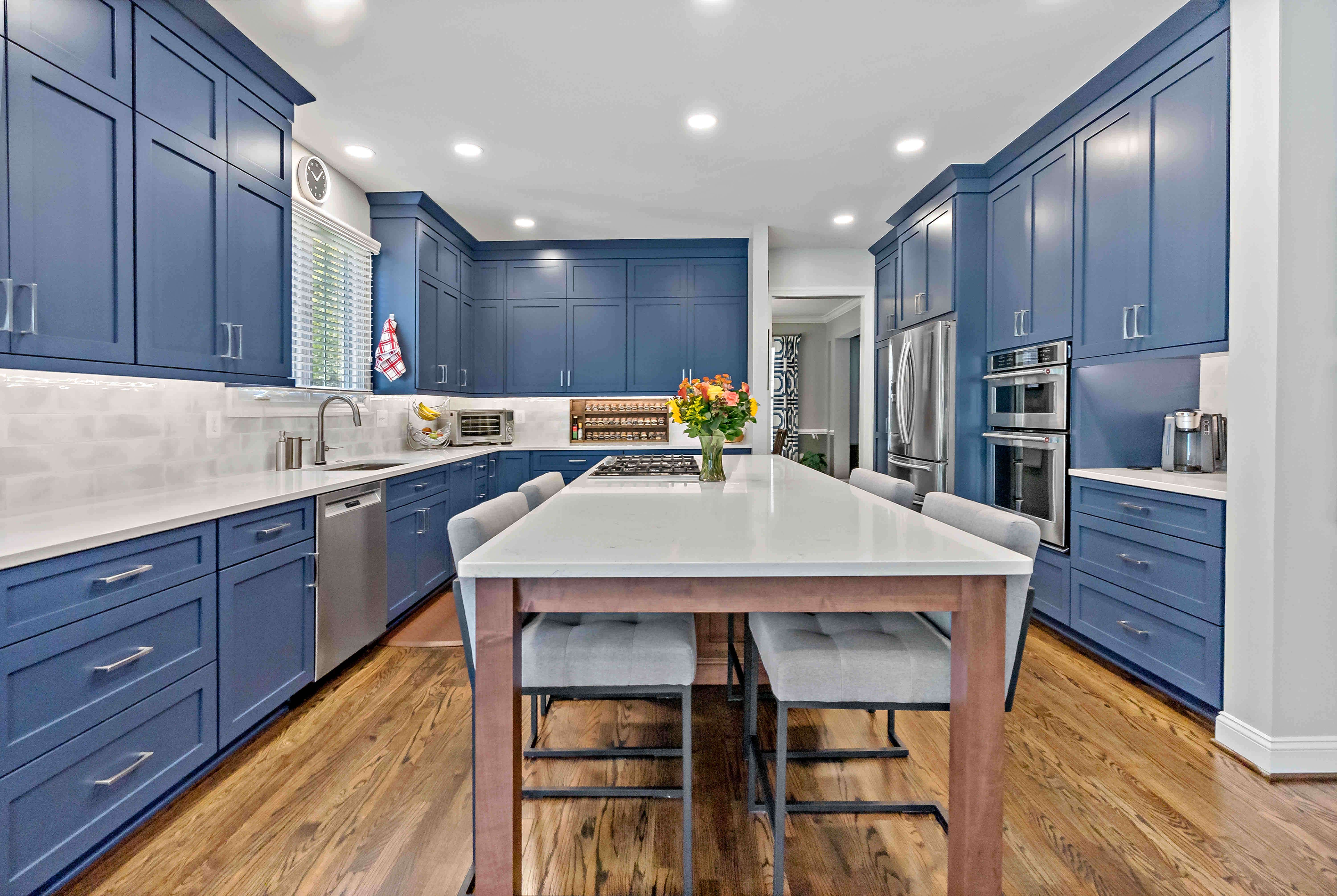 Dark blue cabinets with silver handles in kitchen