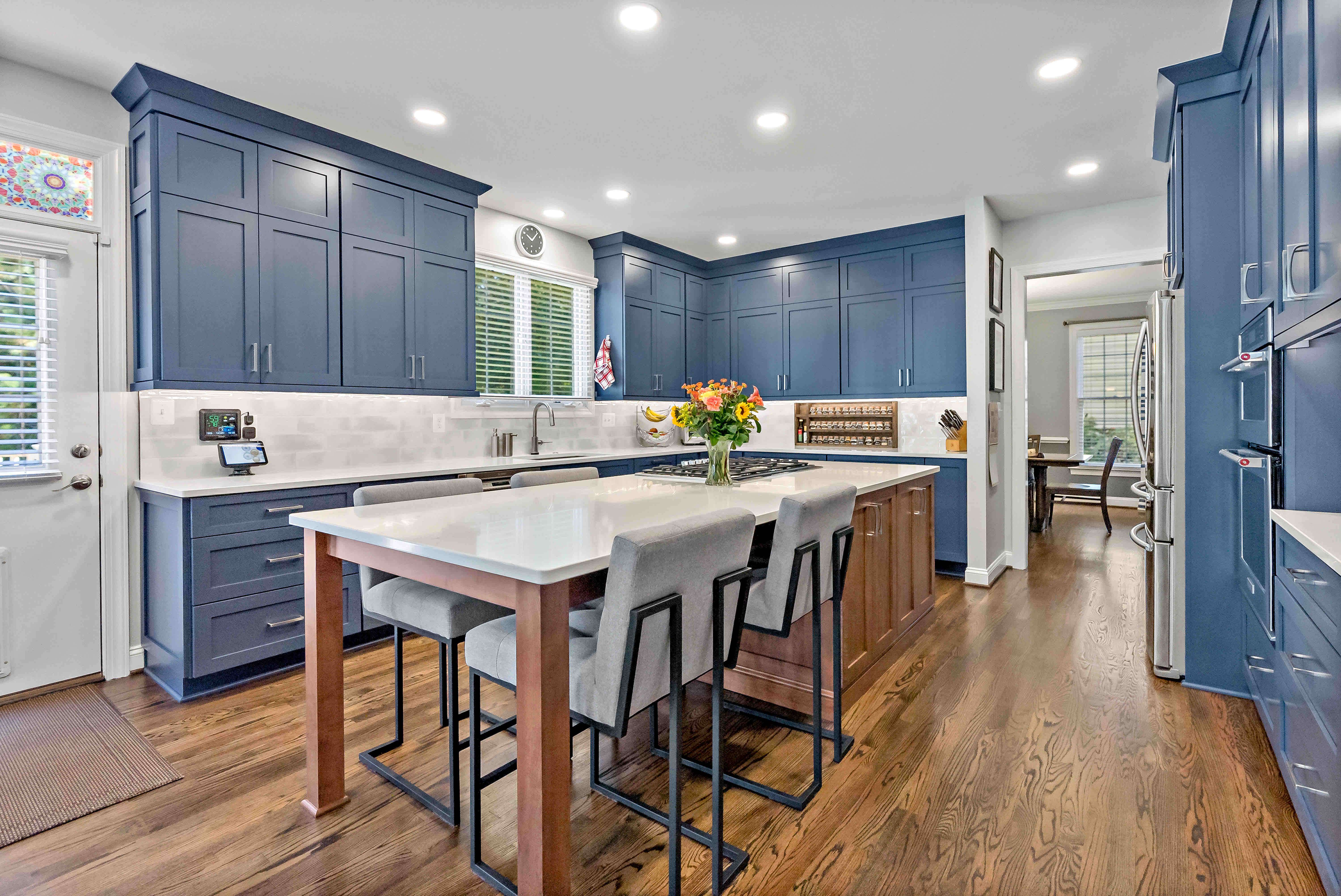 Long kitchen island with seating in blue kitchen