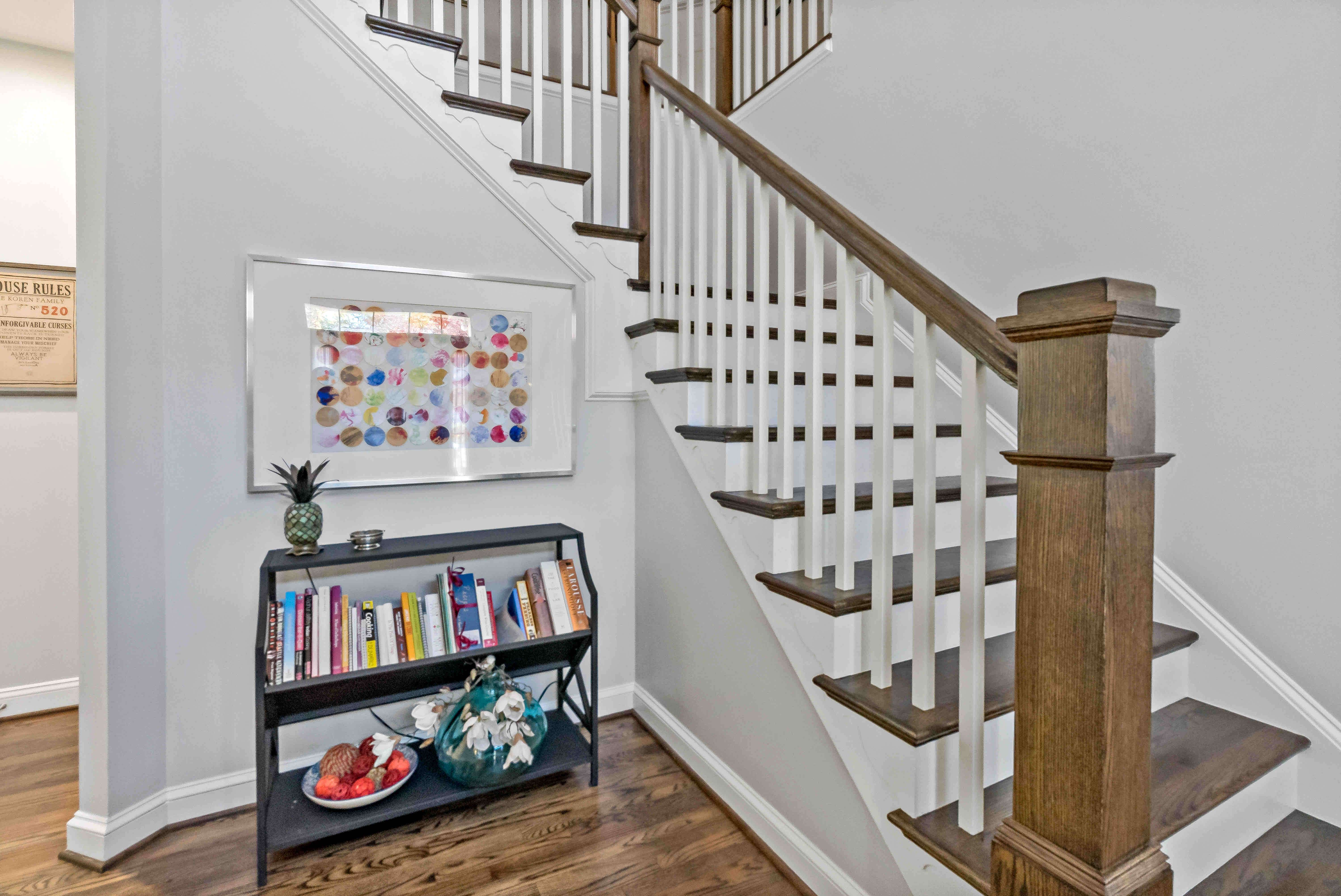 White and brown wooden staircase going upstairs