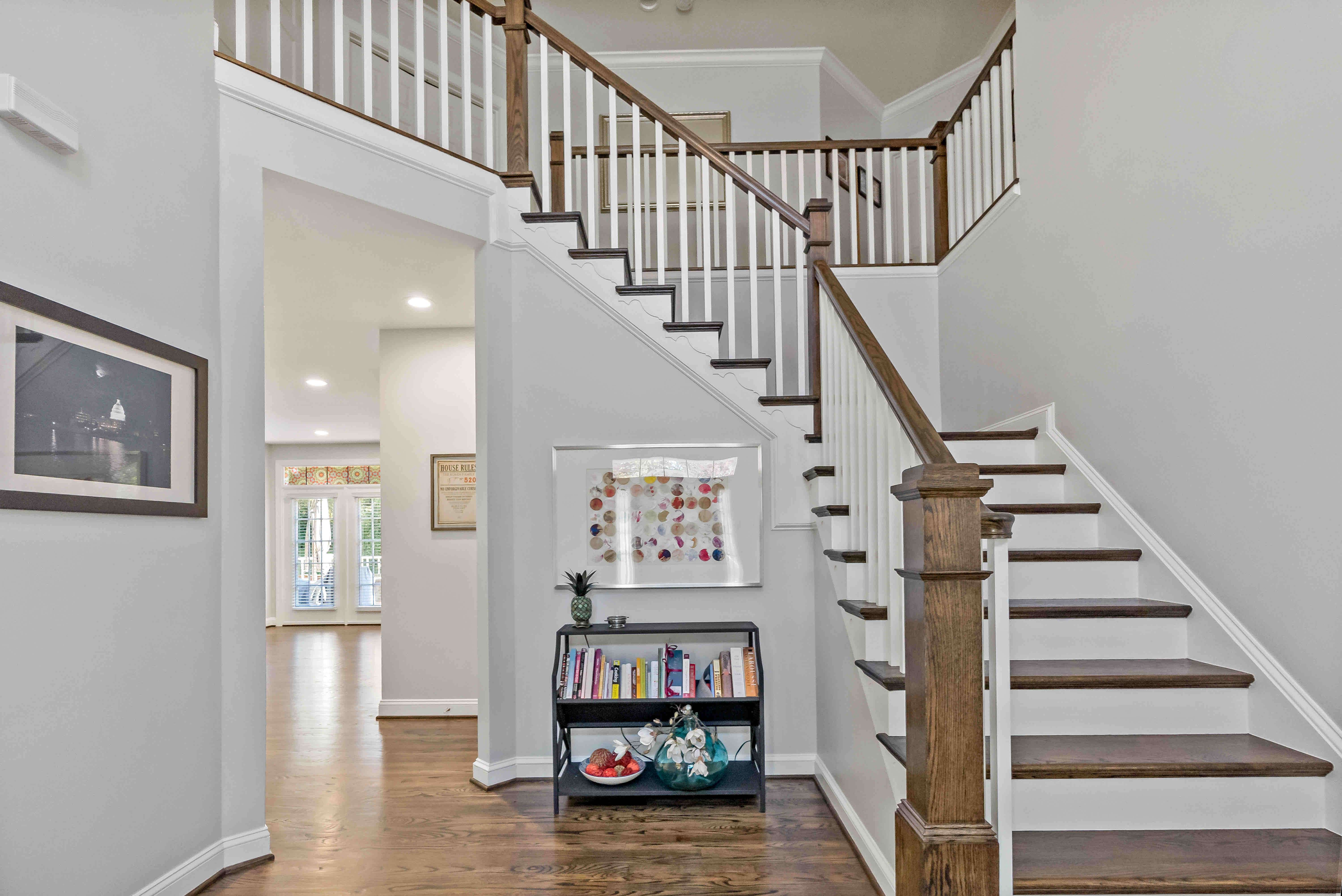 Foyer with white and brown staircase