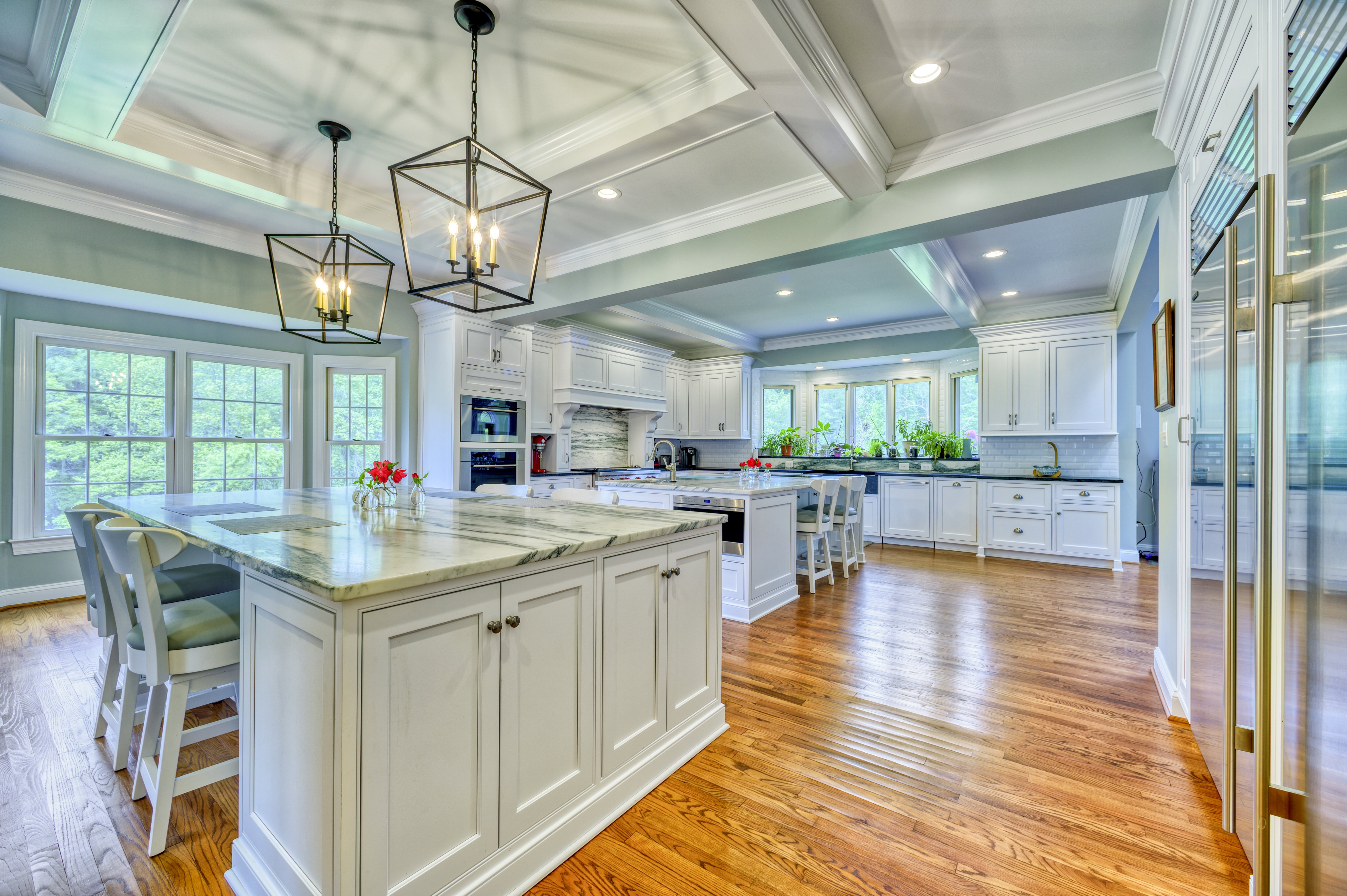 White kitchen island with seating with granite countertops