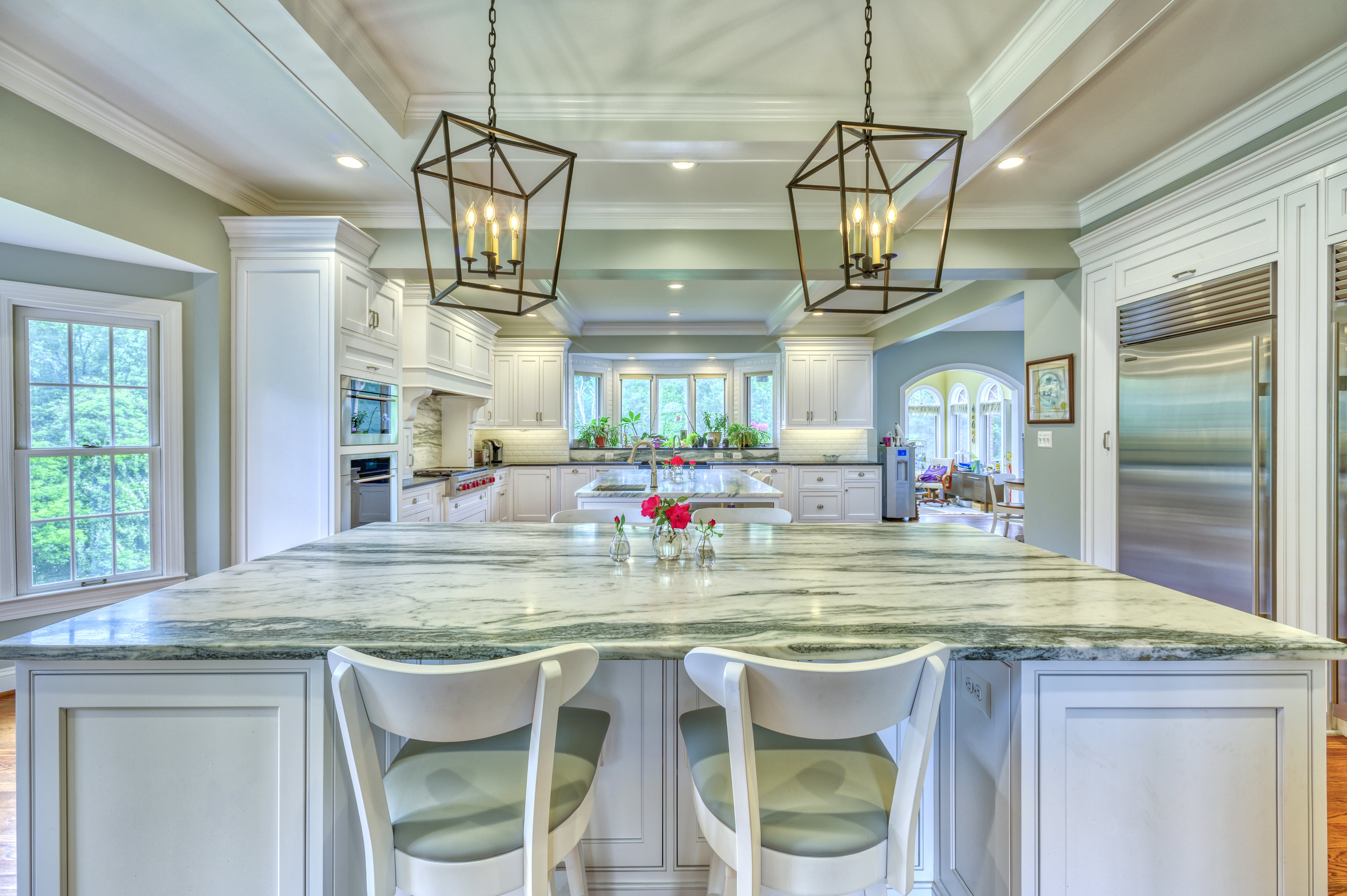 Kitchen island with granite countertop and pendant lighting above