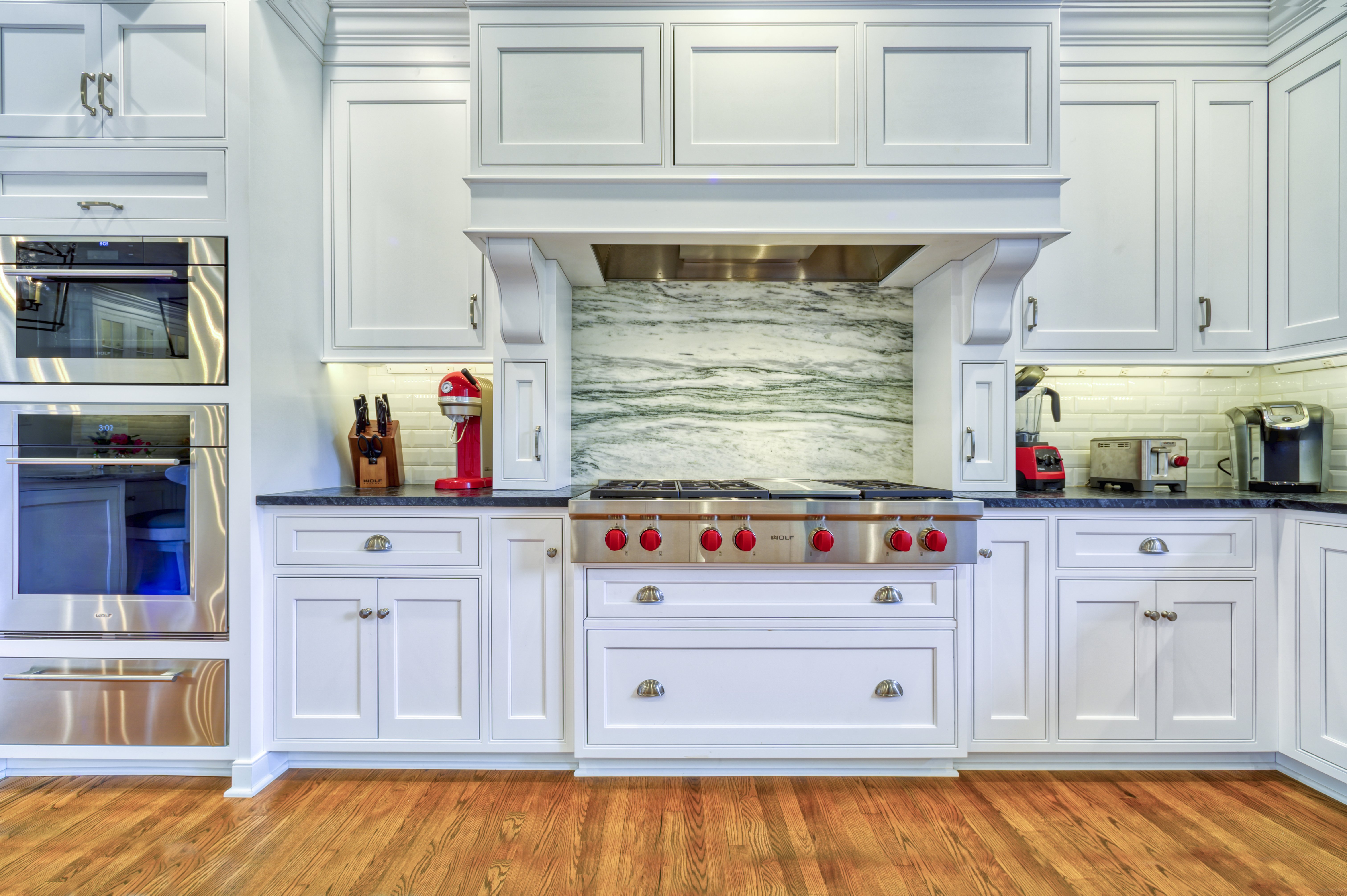 White cabinets with ample storage around stove in kitchen