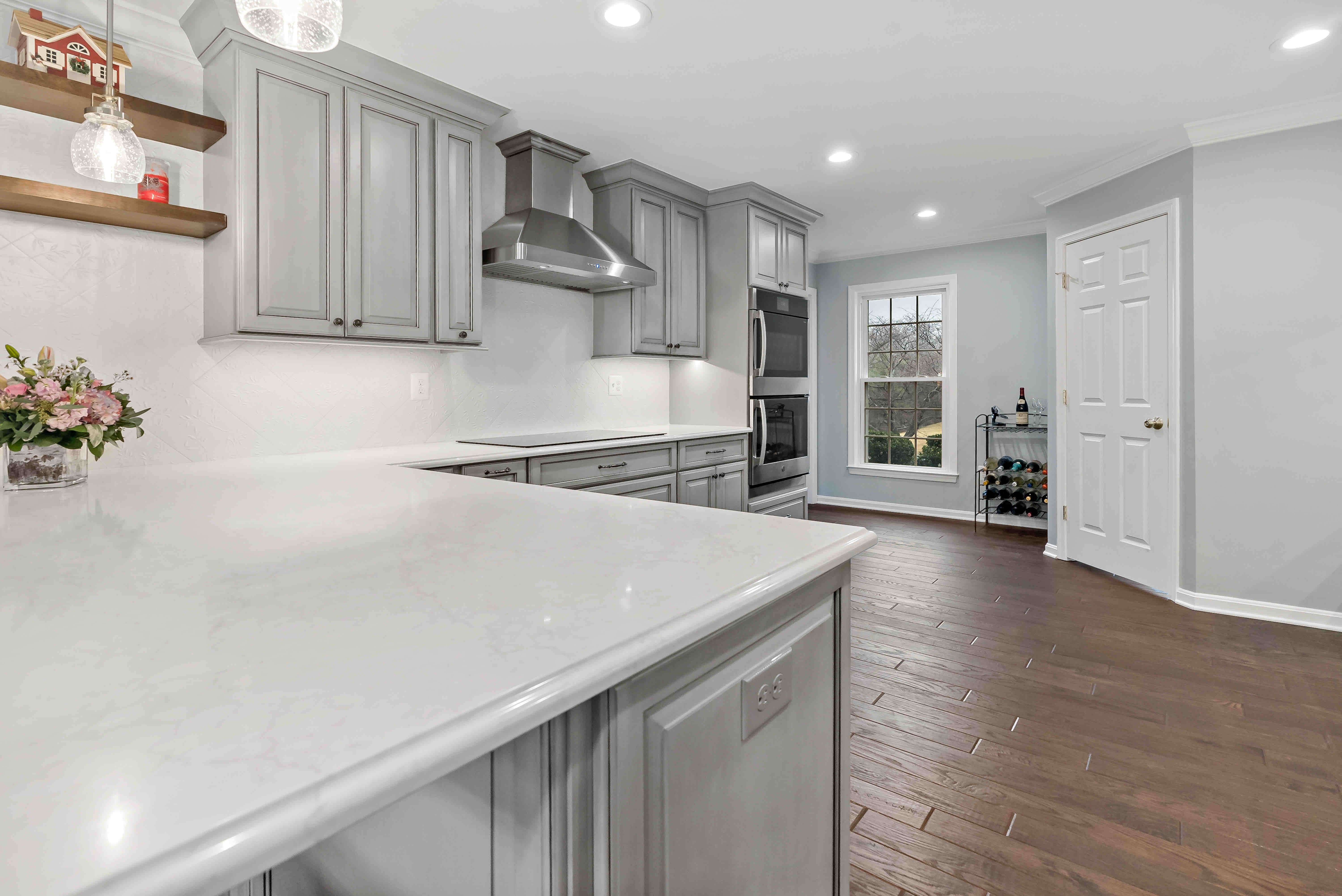 White countertops and grey cabinets in kitchen