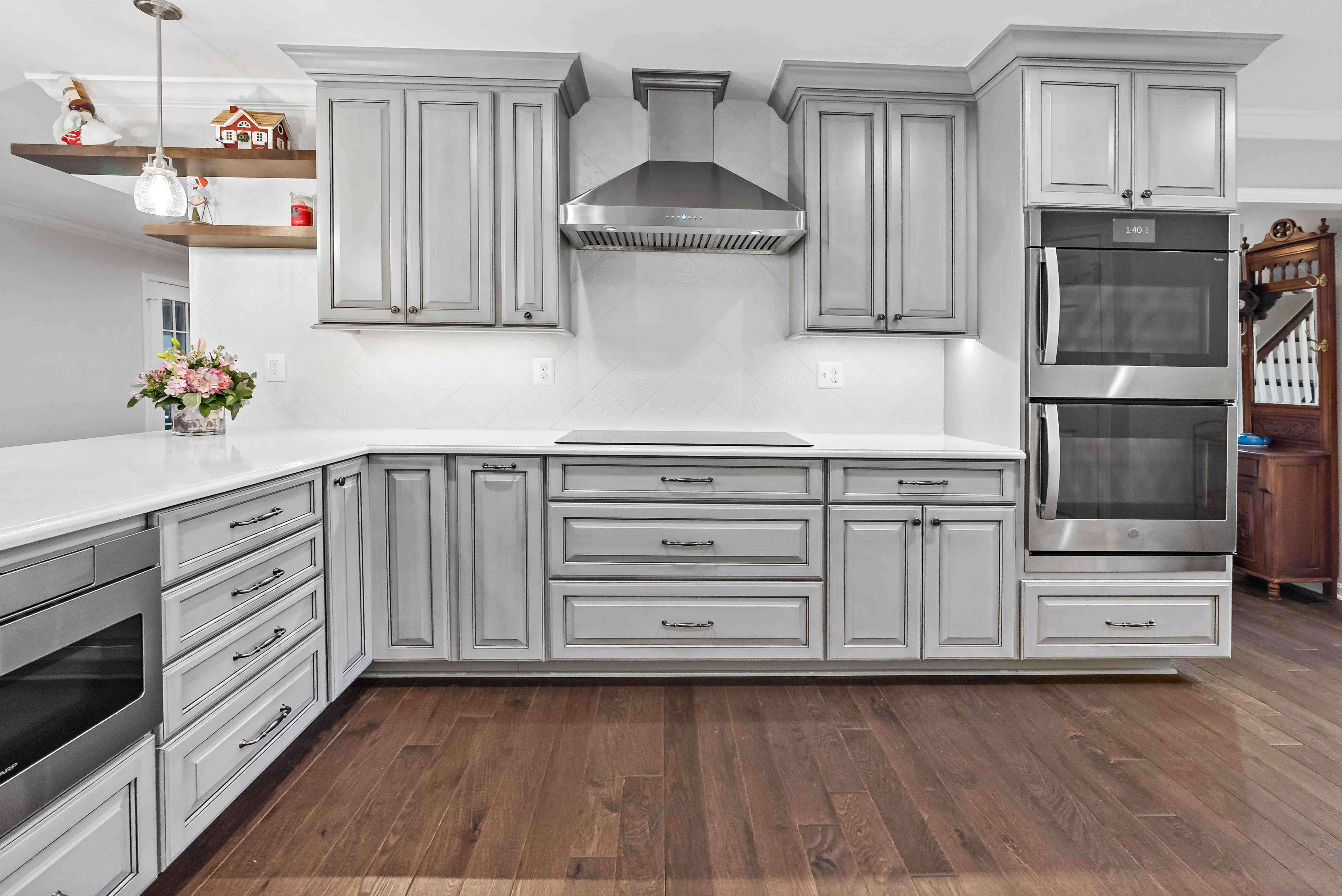 Grey kitchen cabinets with white backsplash