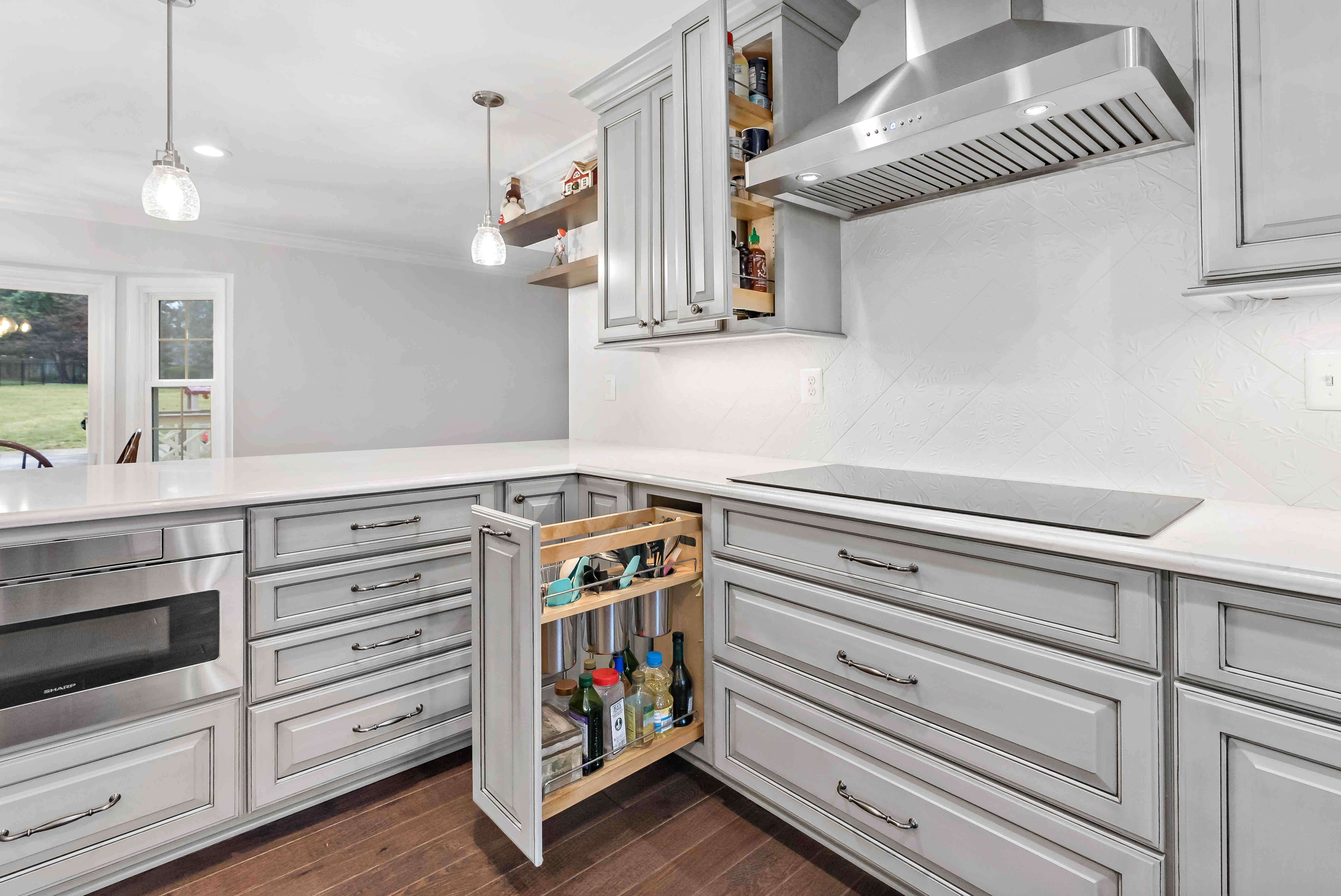 Grey cabinets with dark grey handles in kitchen
