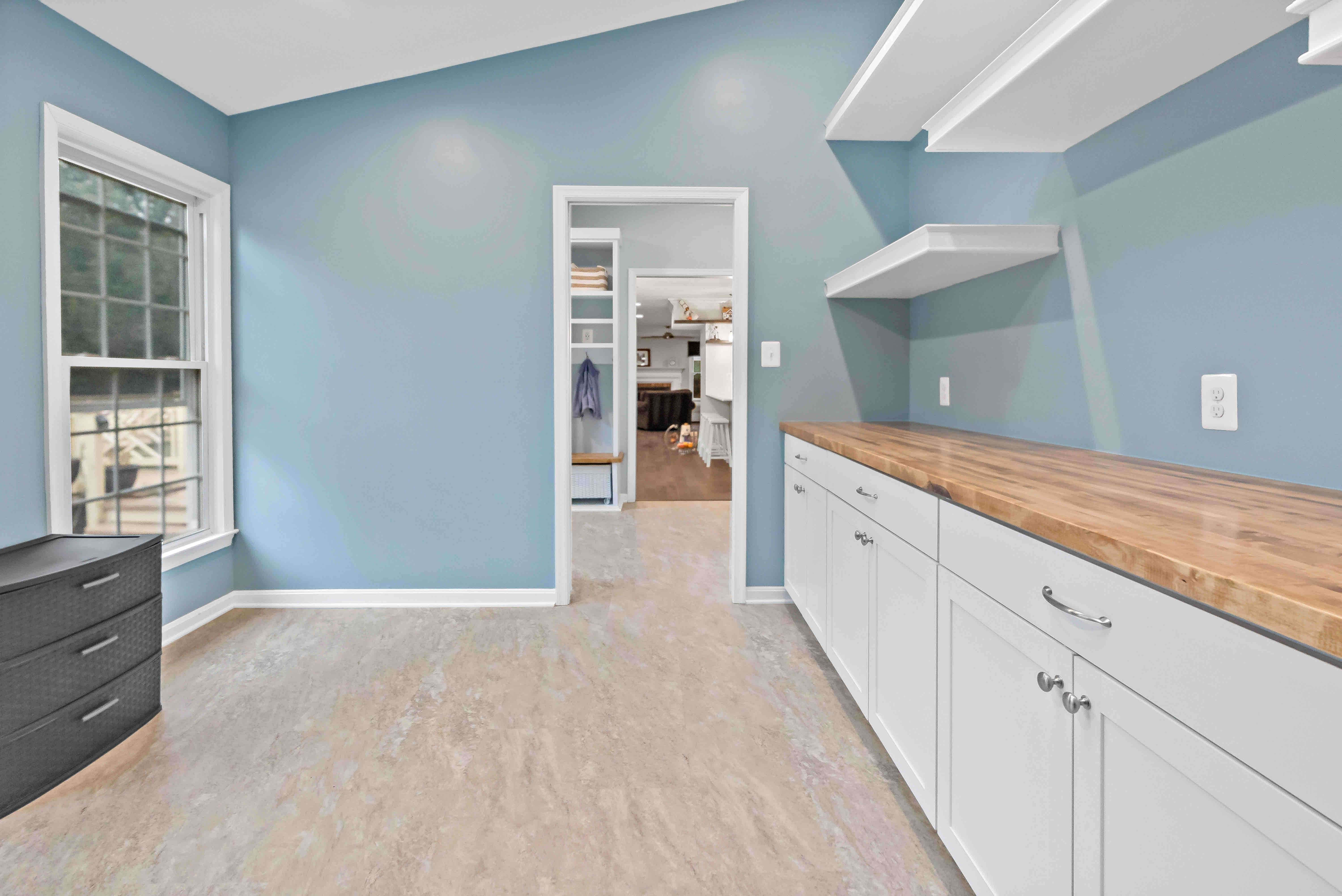 Open room with floating shelves and blue walls