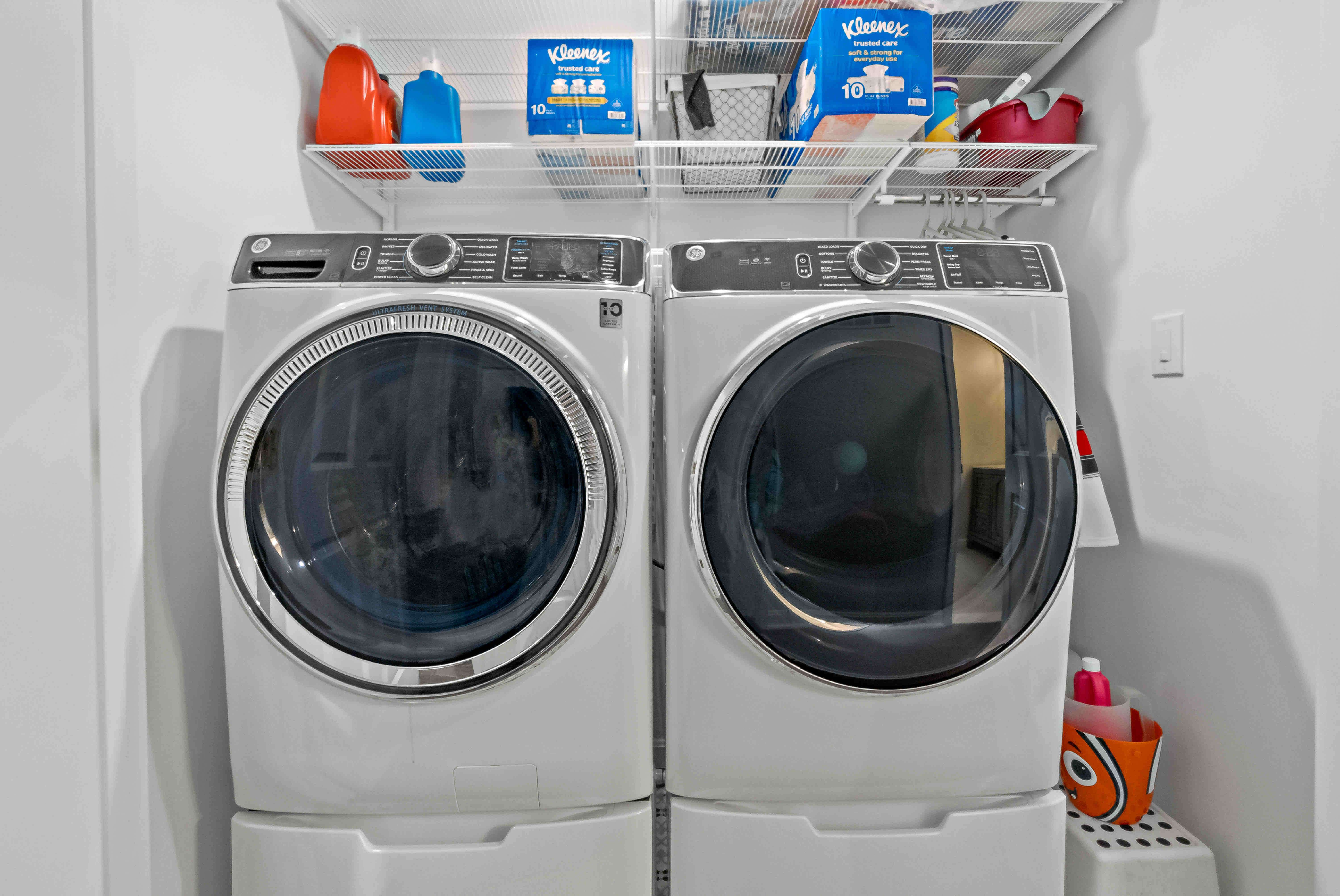 Laundry room with shelving above