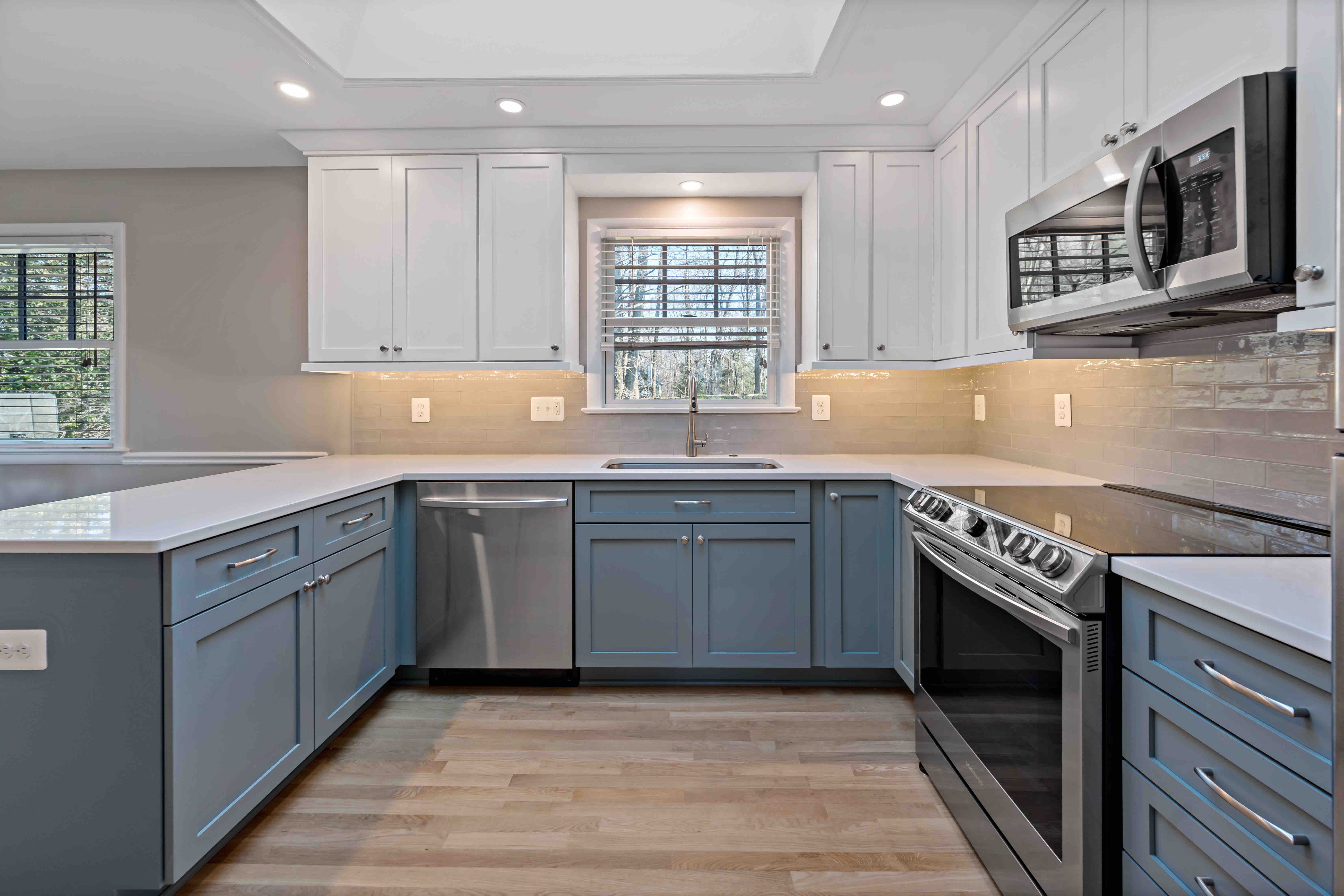 Silver appliances with window above sink in kitchen