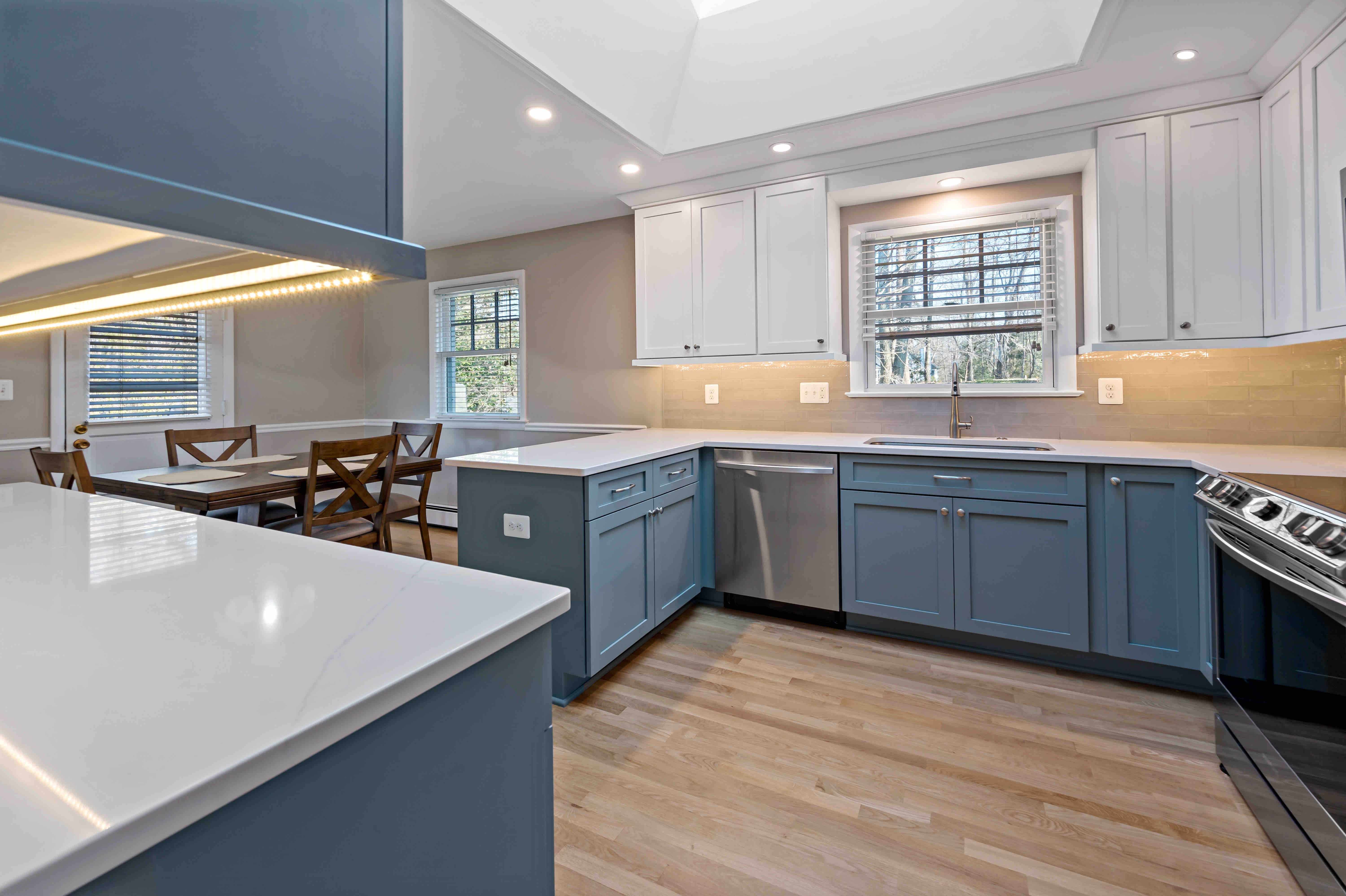 White upper cabinets and countertops in Oakton kitchen