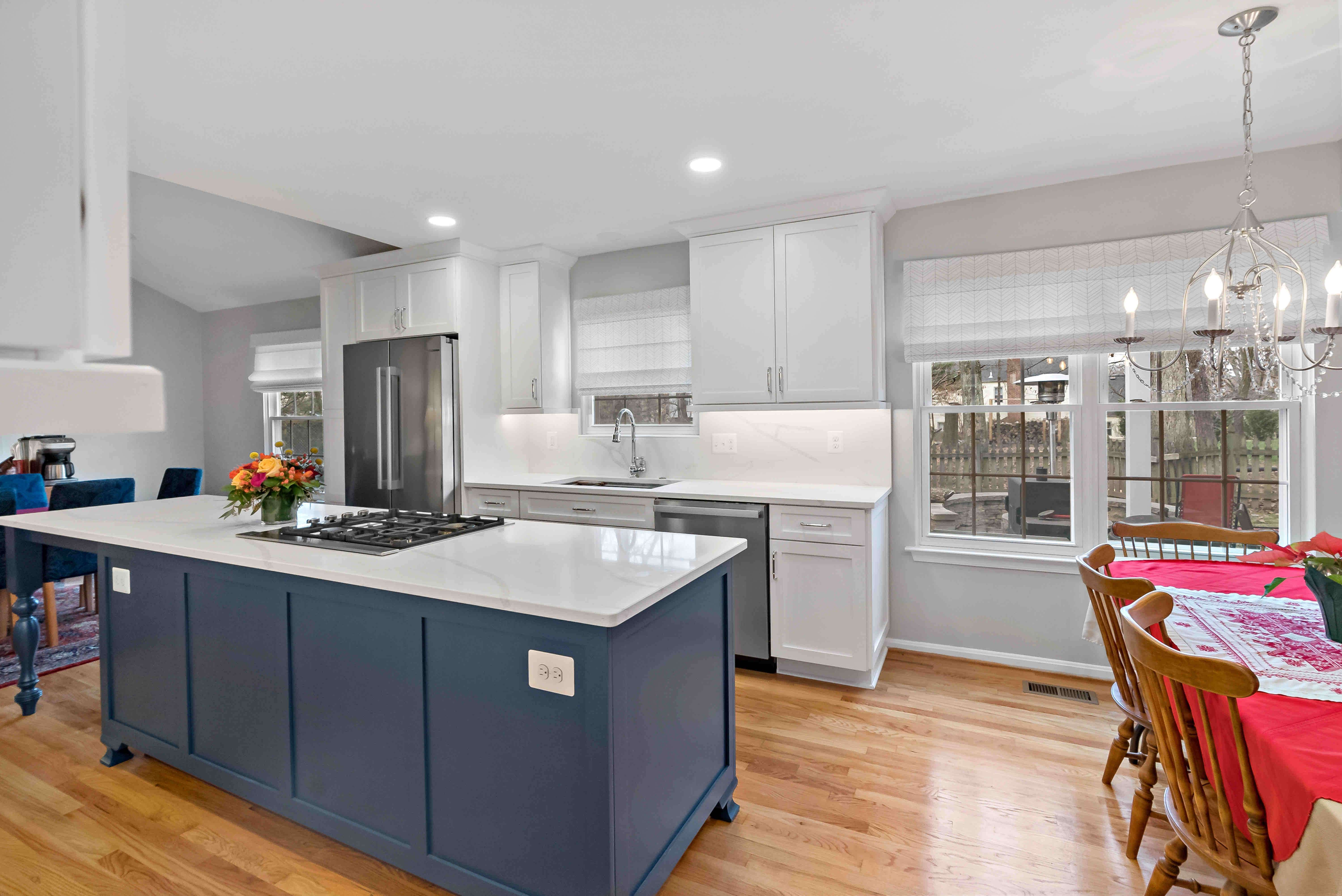 White kitchen with dark blue island
